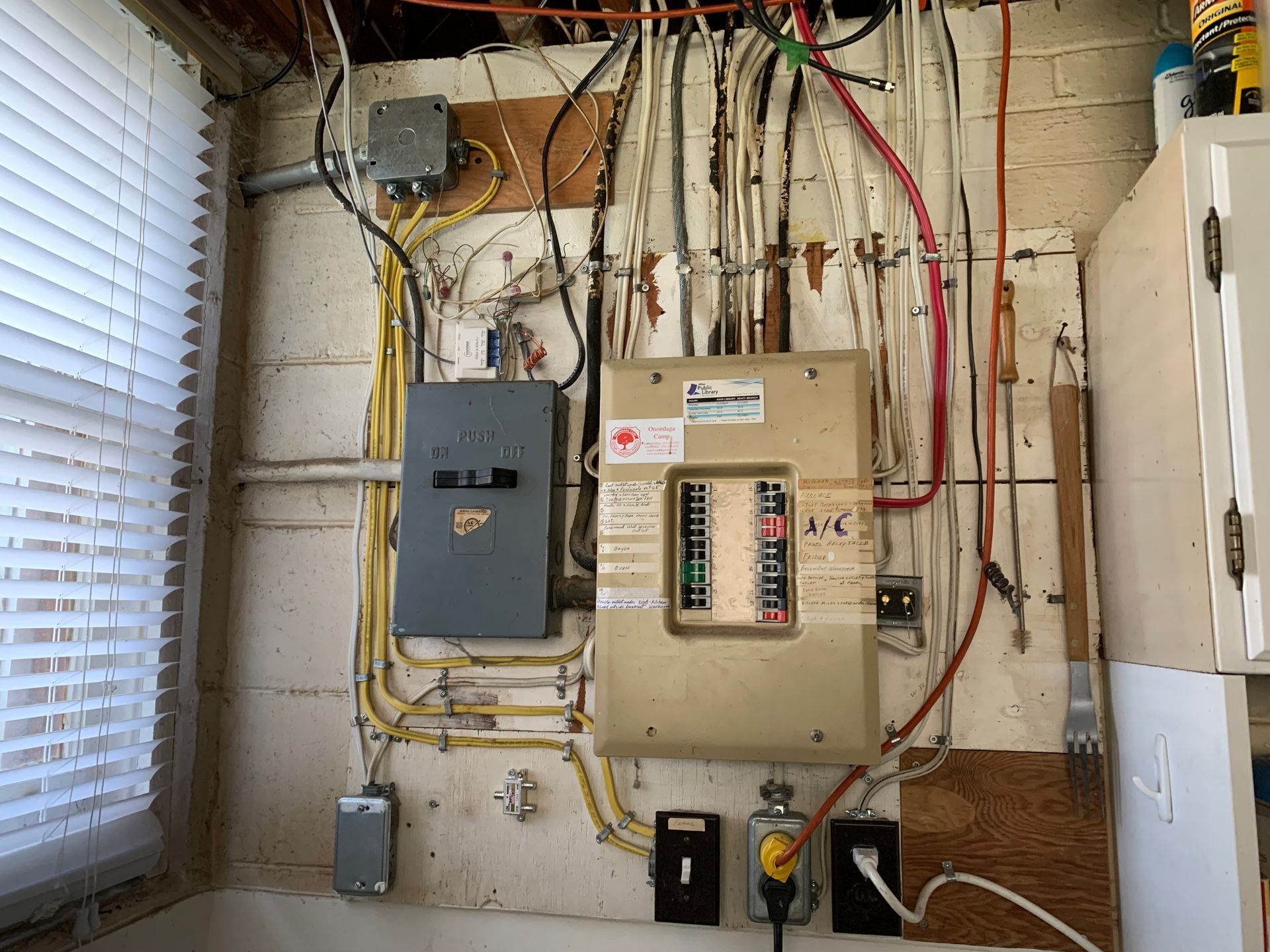 A wall with a lot of wires hanging from it