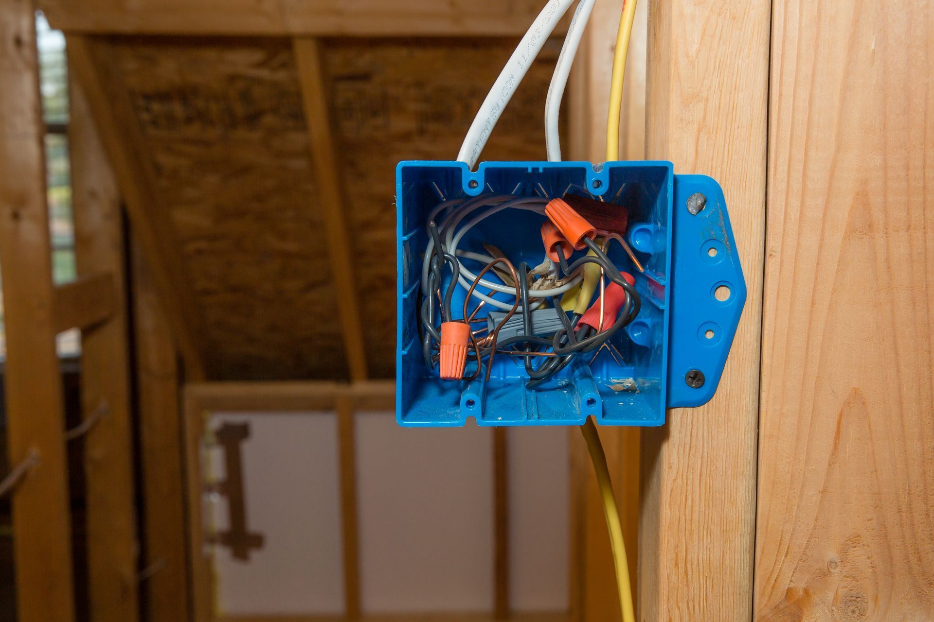 An electrician is working on an electrical box.