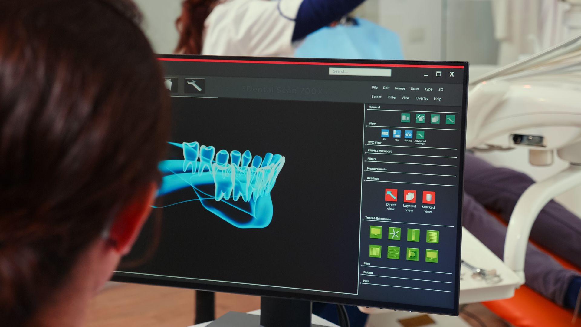 Dentist reviewing 3D dental implant scan on computer in modern dental office