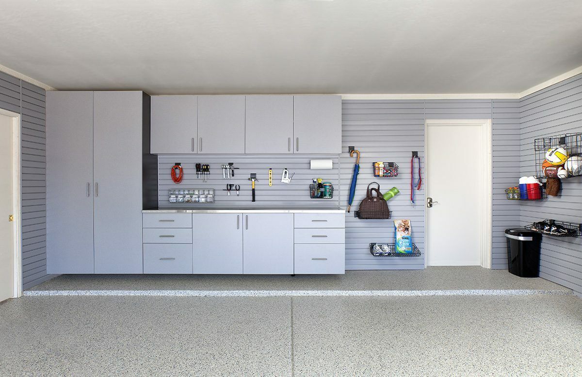 Picture of an organized garage with custom grey shelving. 