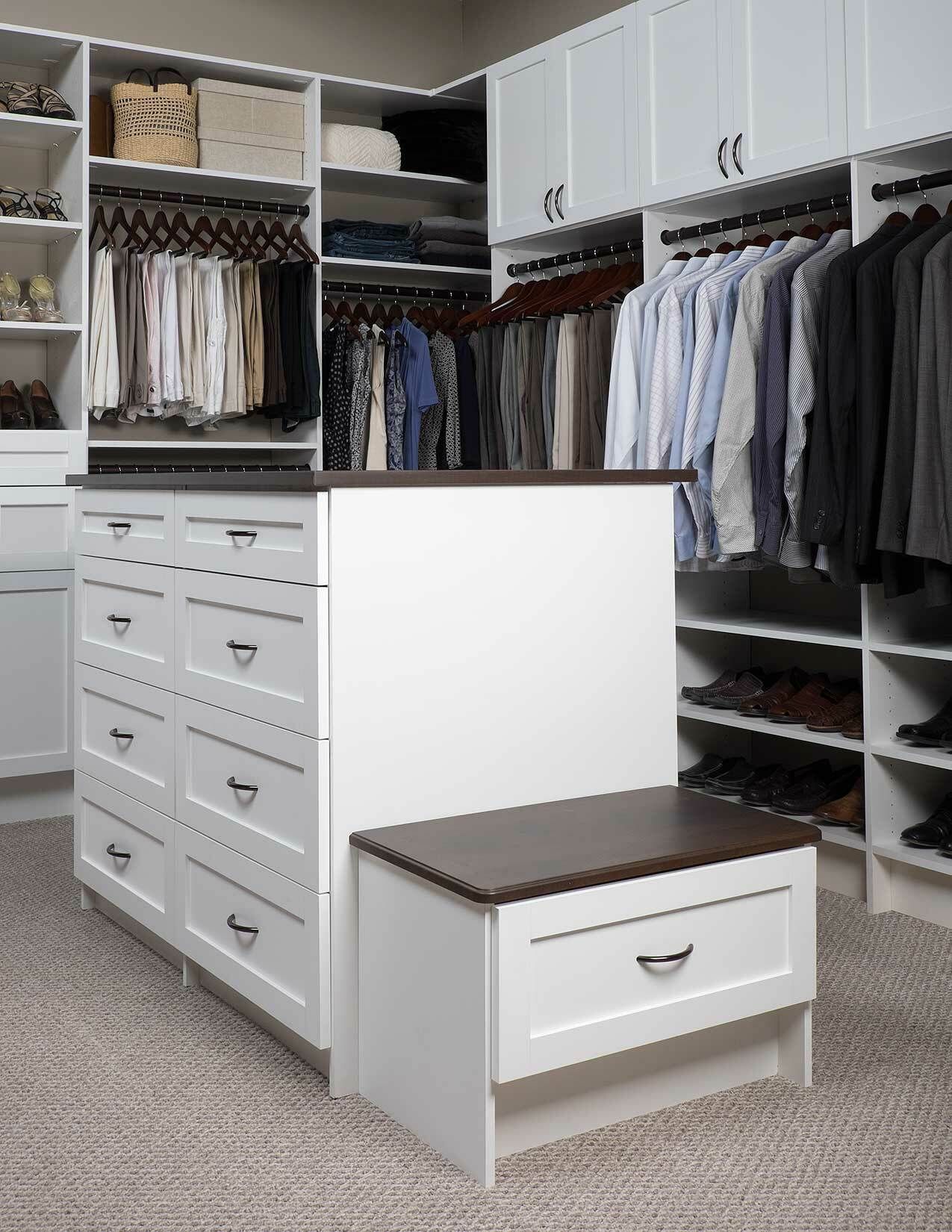 Closeup of a custom, organized closet with white shelves. 