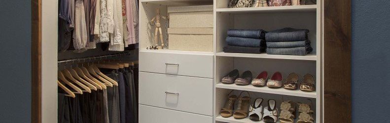 Close up of a custom closet with white built-in shelving