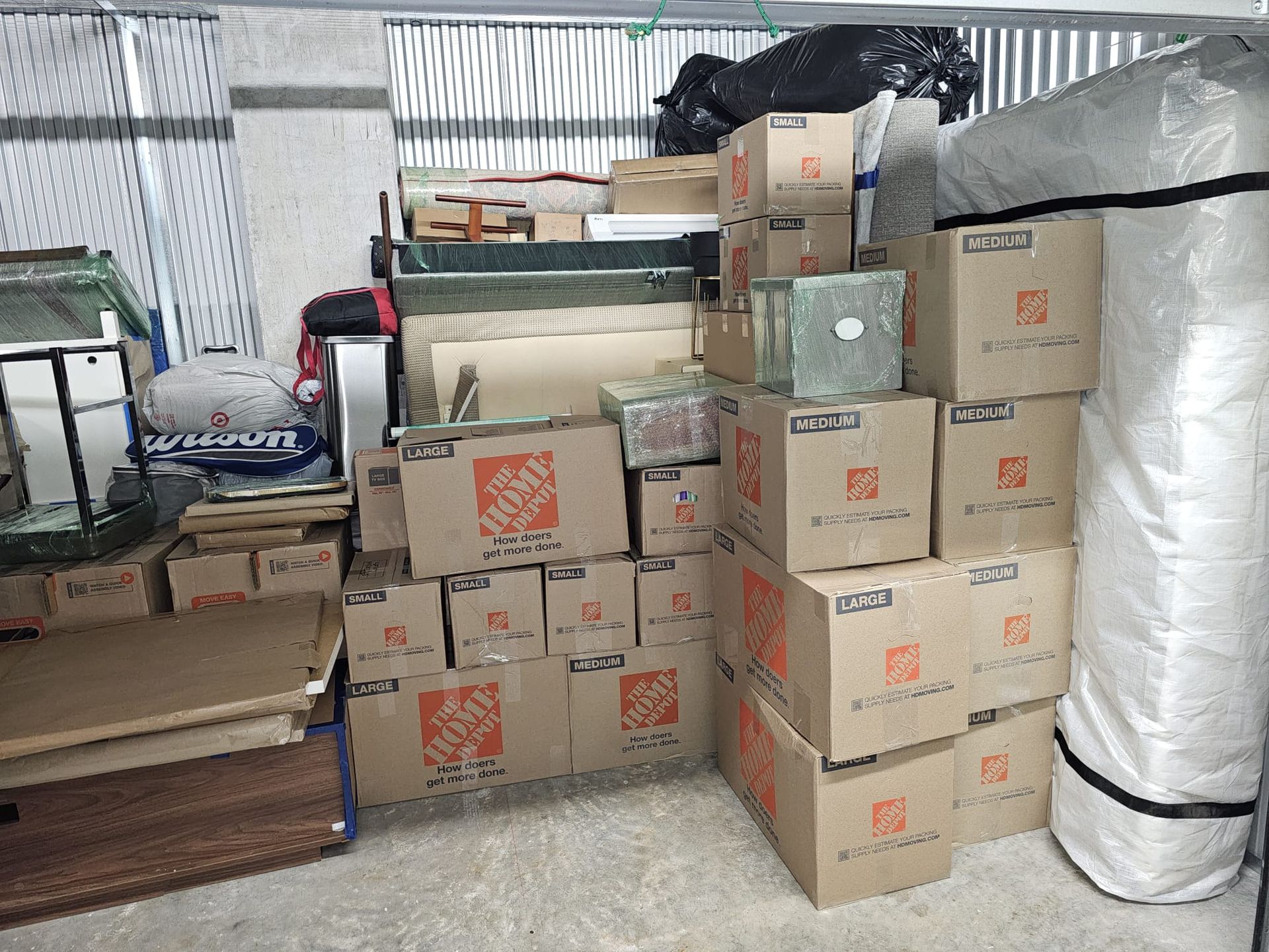 A bunch of boxes are stacked on top of each other in a room.
