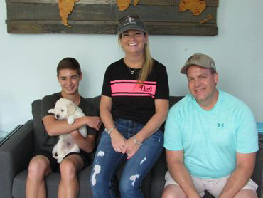 A Teen Holding Puppy With His Family - Livermore, CO - Marlos Golden Retrievers