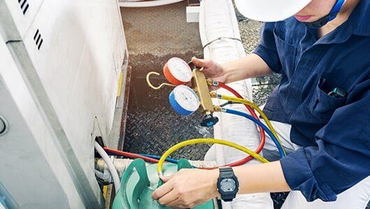 Air Conditioning — Technician Checking Air Conditioner in Dallas, TX
