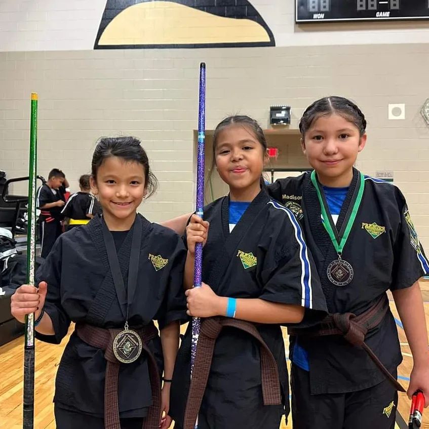 A person is holding a sparkler in their hand in the dark.