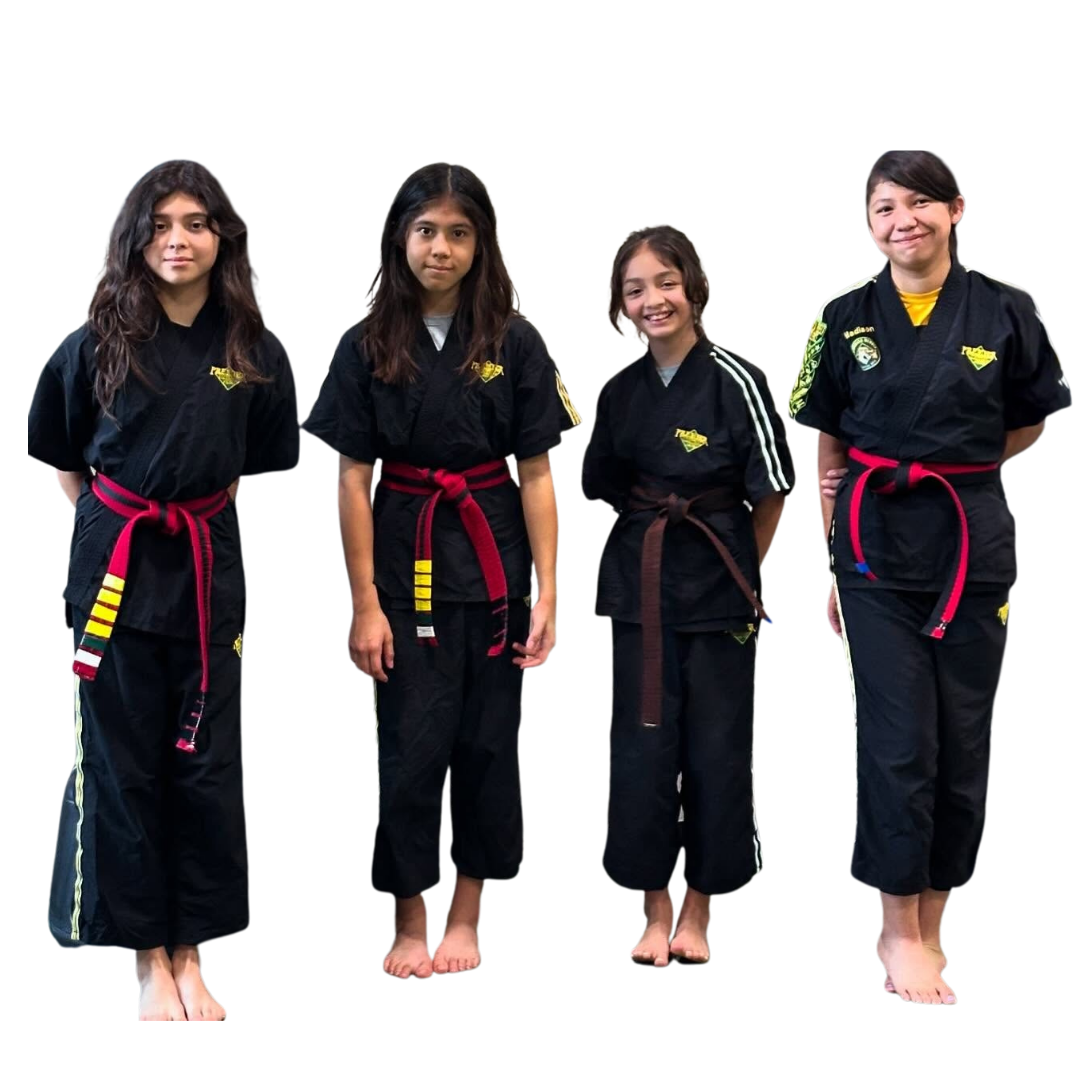 A boy and two girls are wearing karate uniforms and pointing at the camera