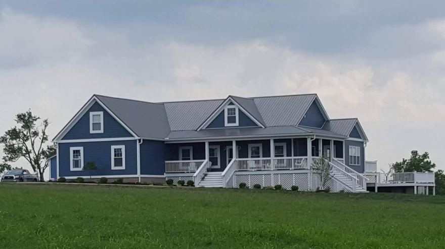 Silver Metal Roof With Blue Siding