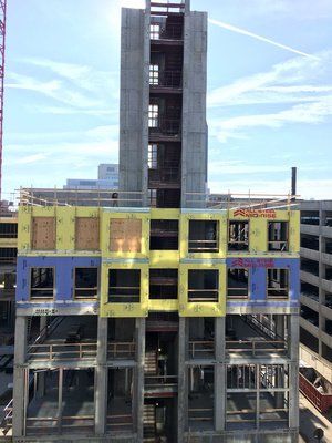 A large building under construction with a lot of windows.