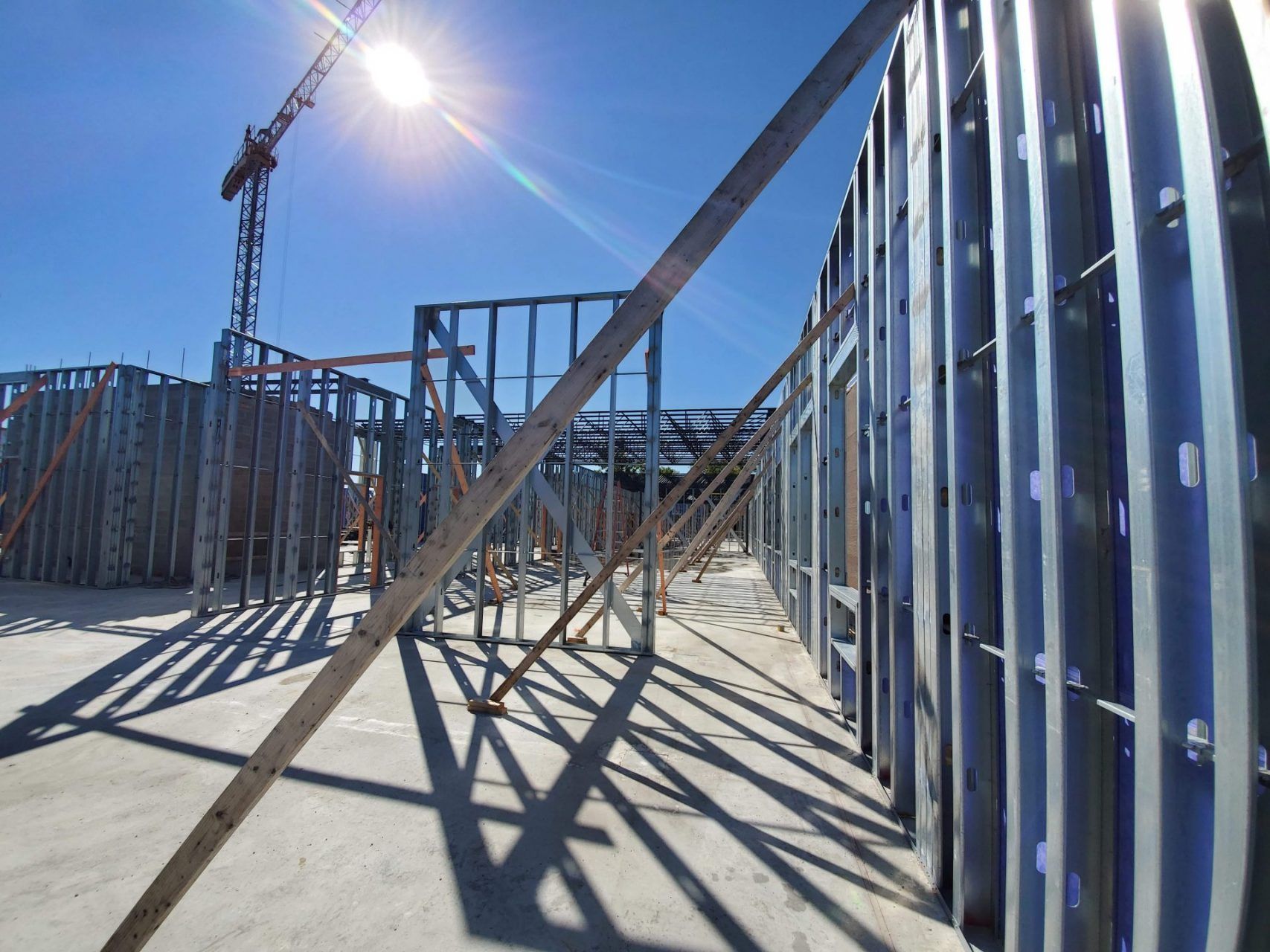 A building under construction with a crane in the background.
