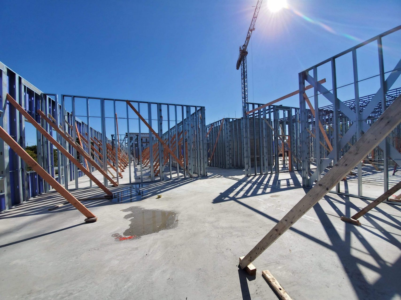 A building under construction with a crane in the background.