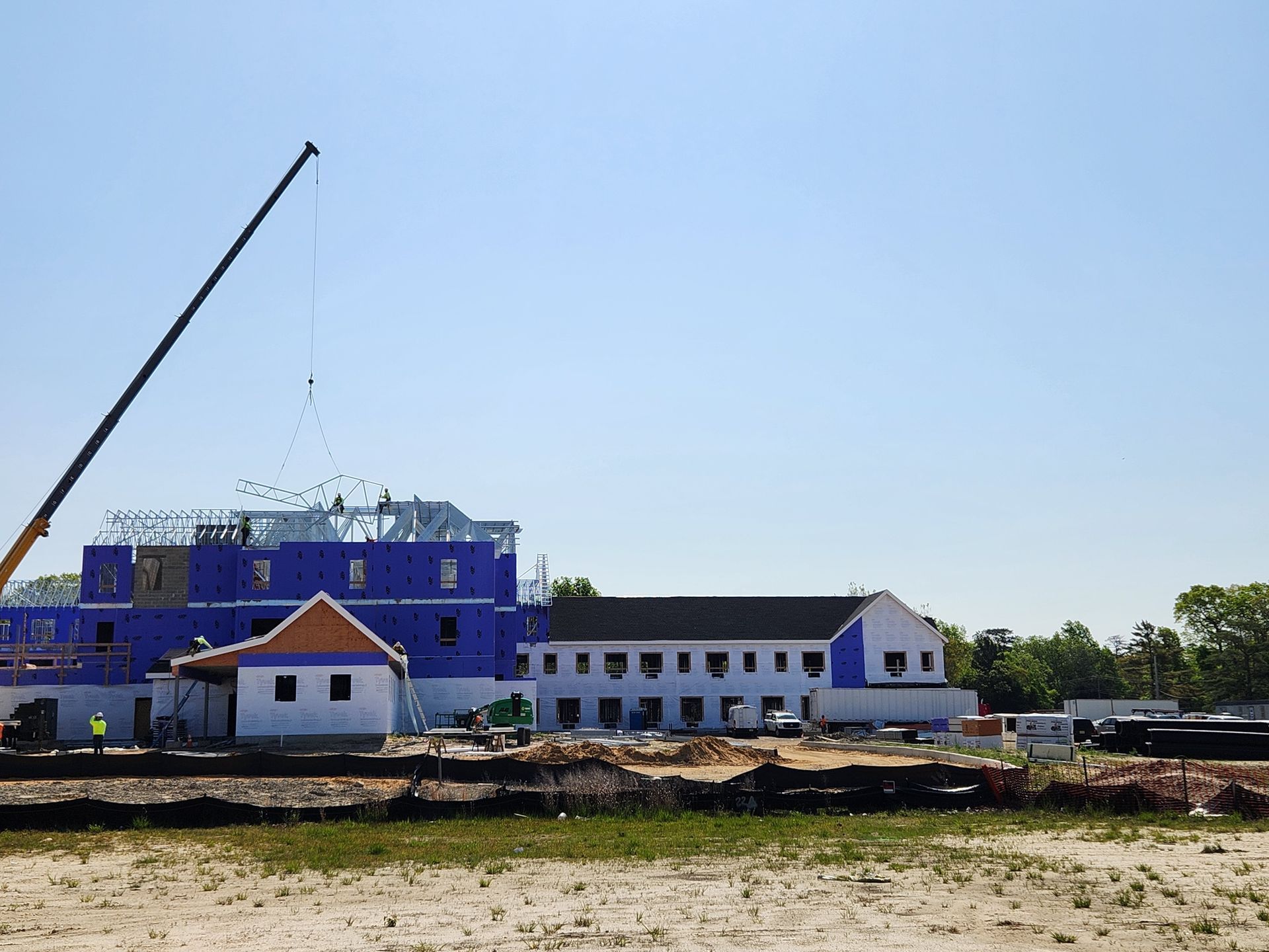 A large building under construction with a crane in the foreground.