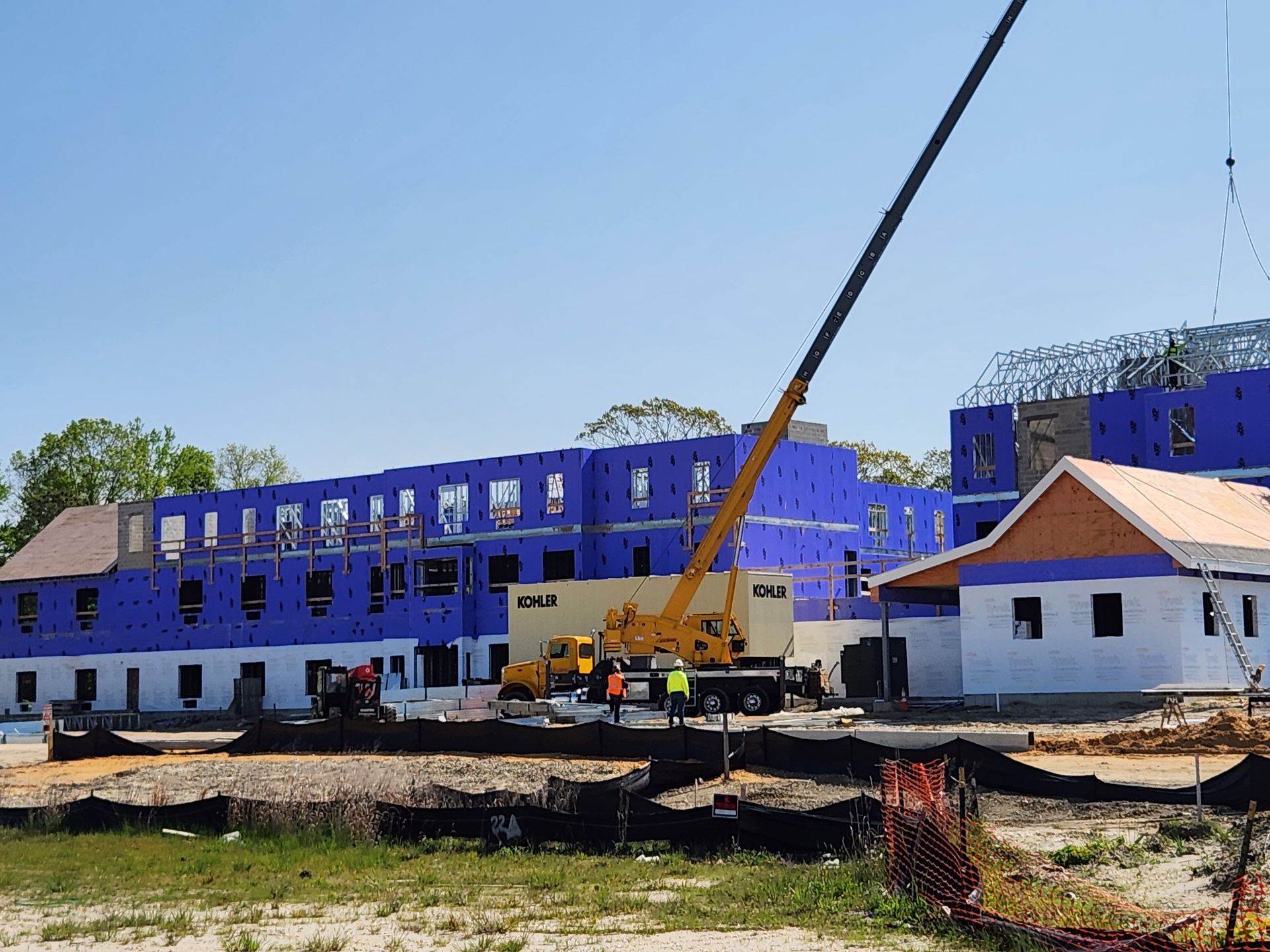 A large building under construction with a crane in front of it.