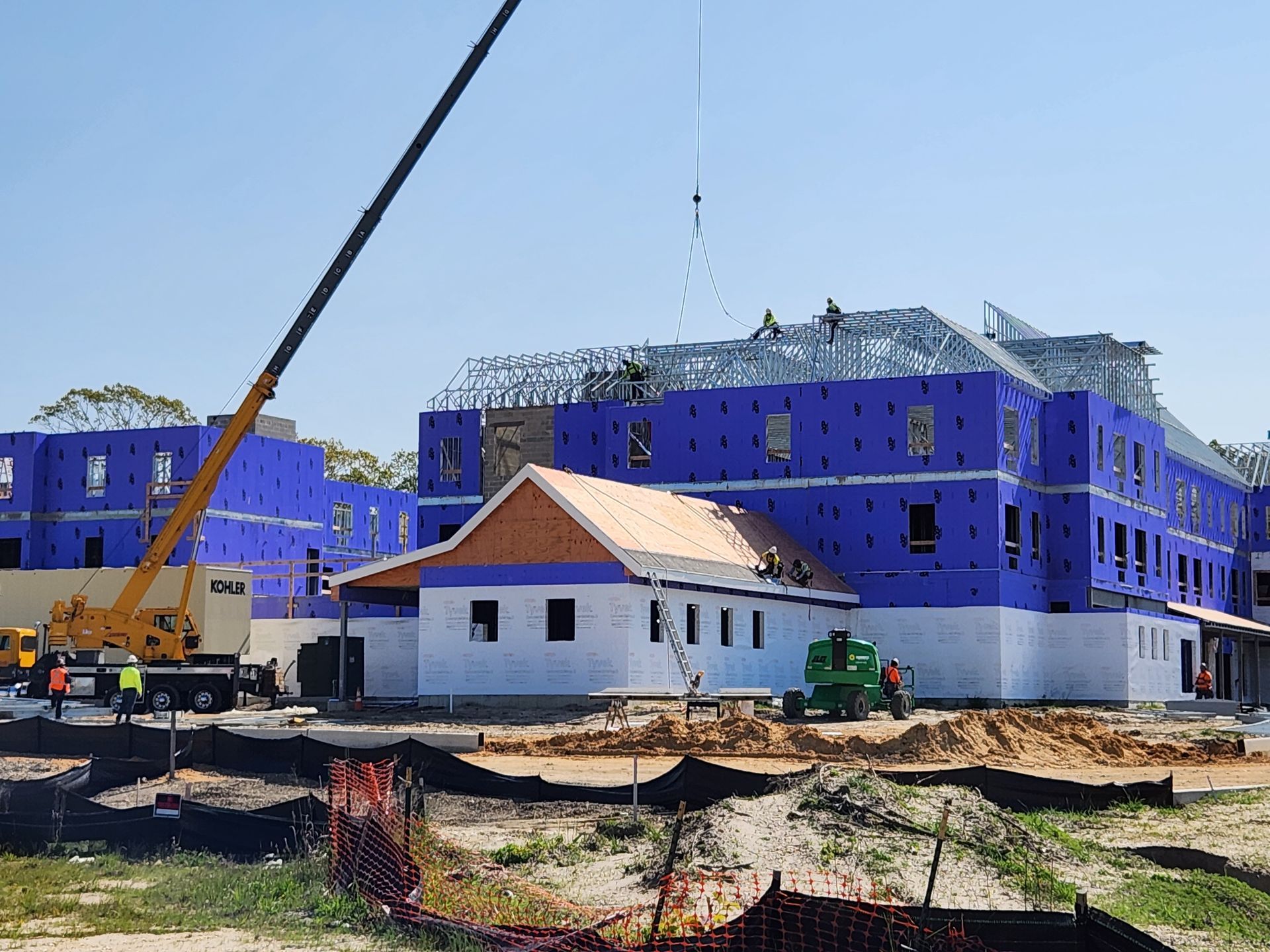 A large building under construction with a crane in the foreground.