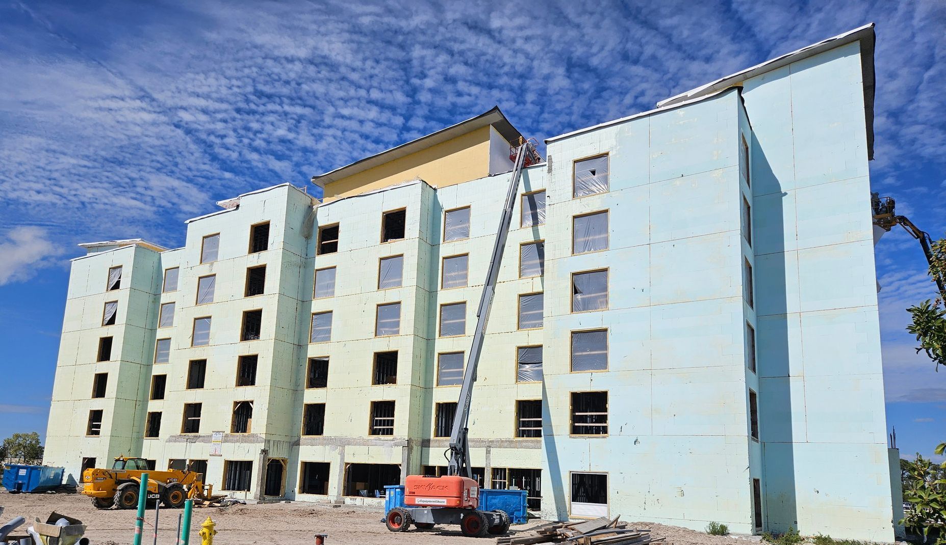 A large building with a lot of windows is being built.