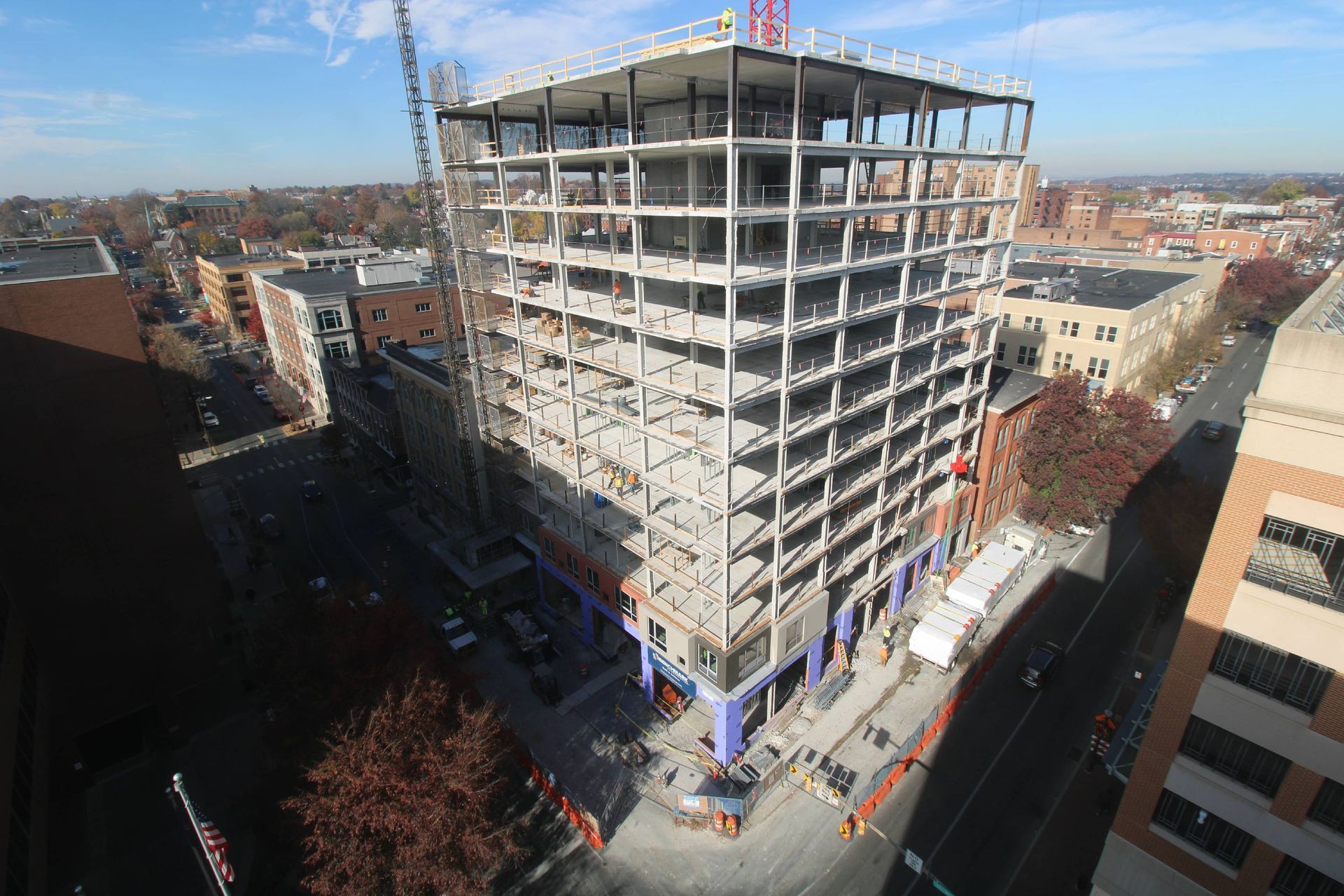 An aerial view of a building under construction in a city.