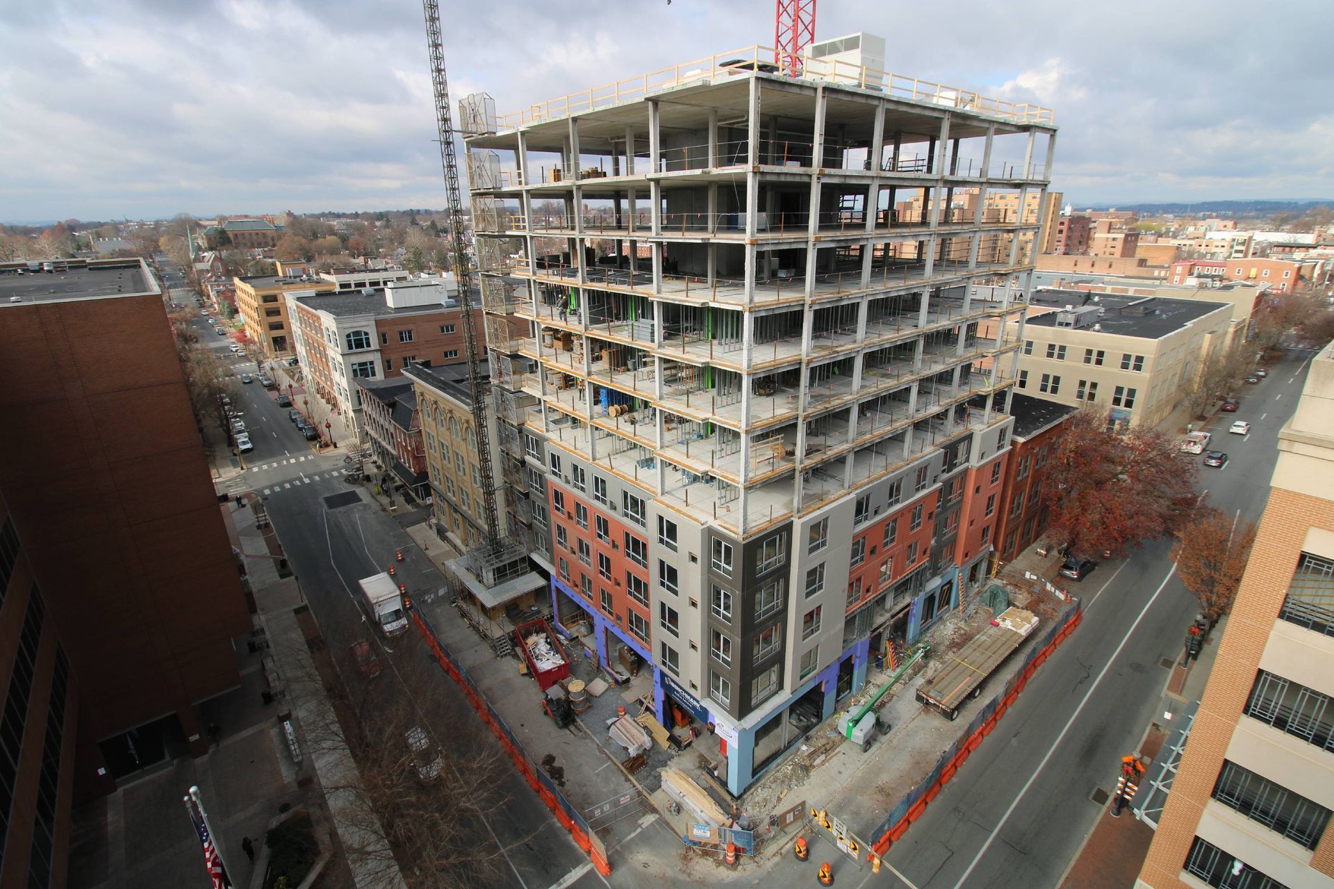 An aerial view of a building under construction in a city.