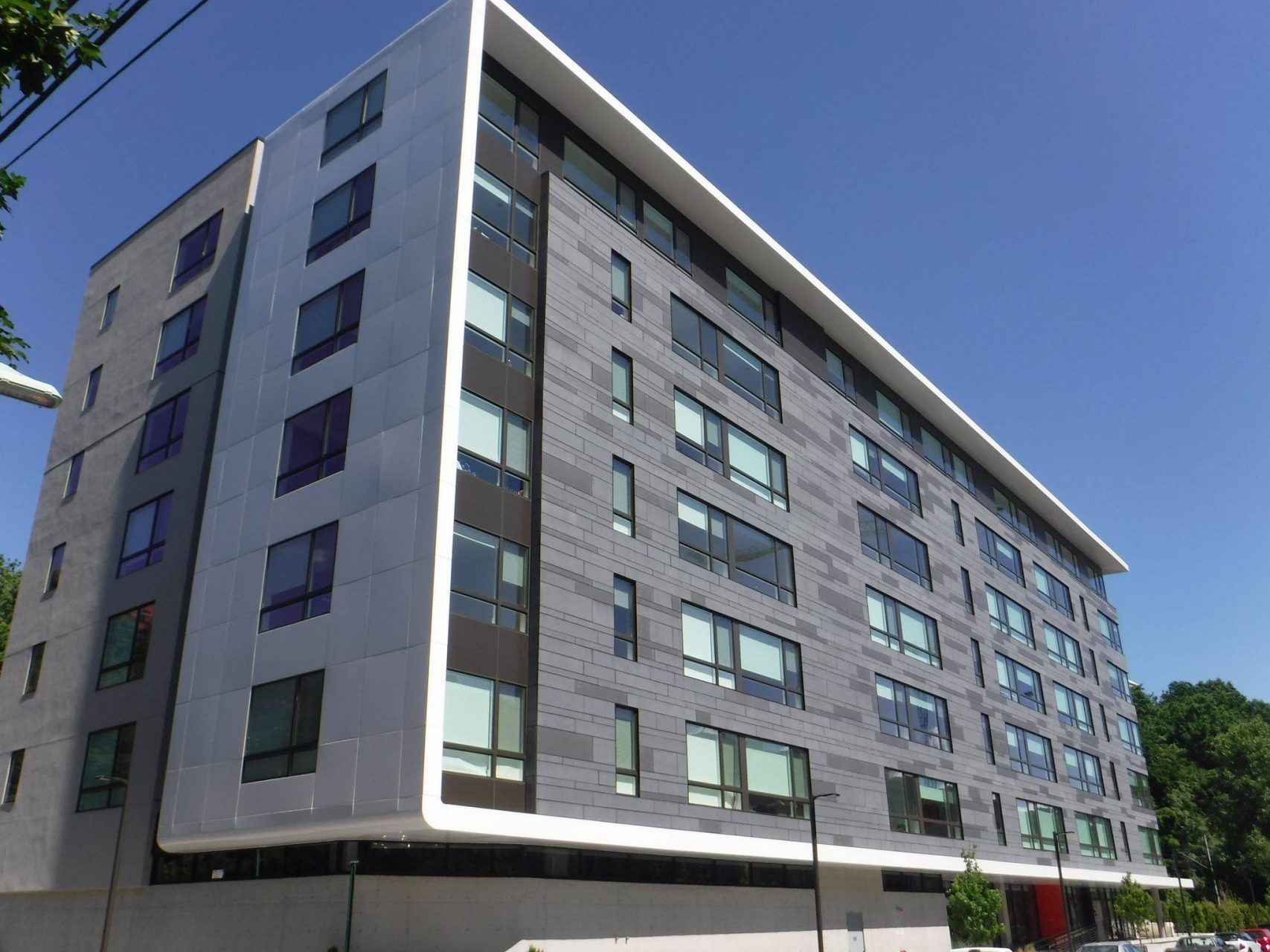 A large building with a lot of windows on a sunny day.