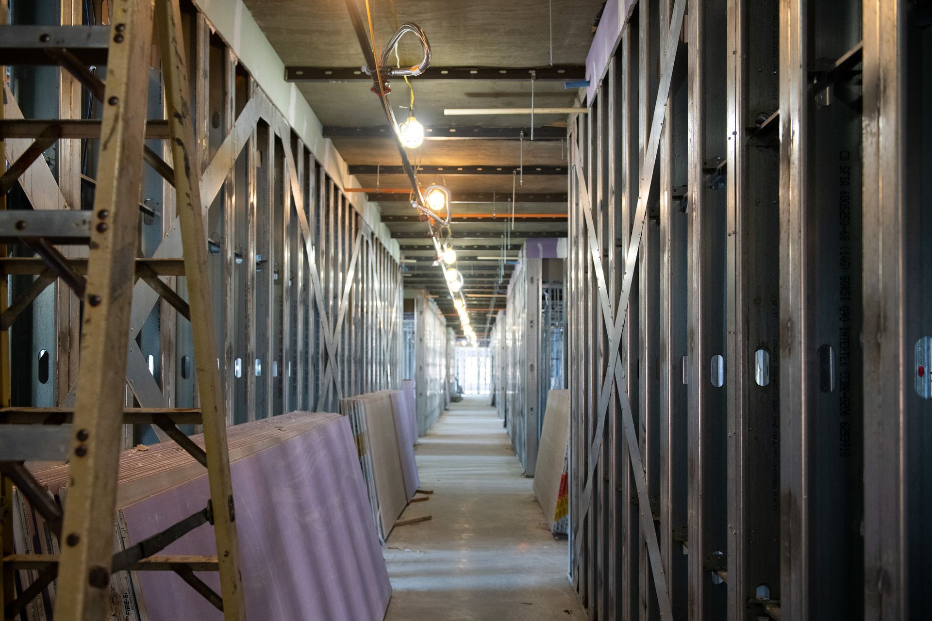 A long hallway in a building under construction.