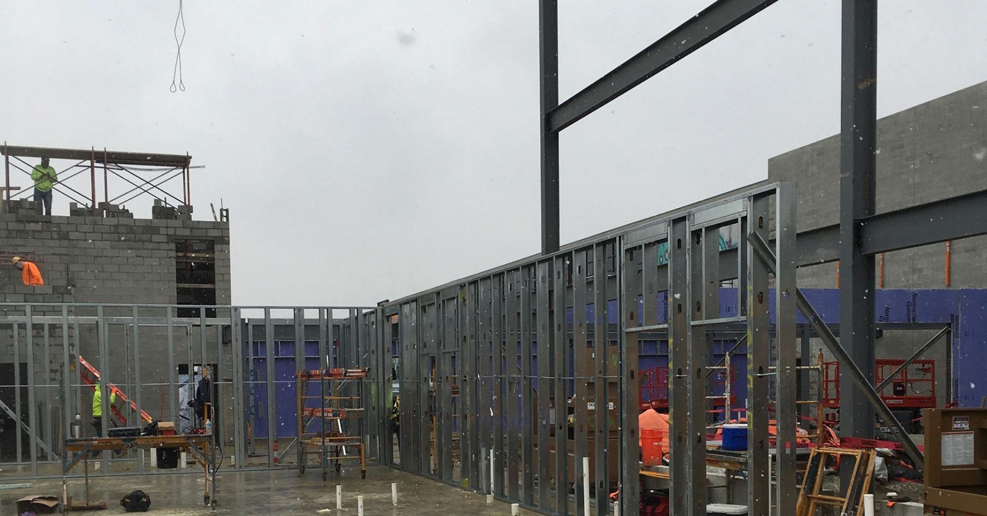 A large building is being built on a cloudy day.