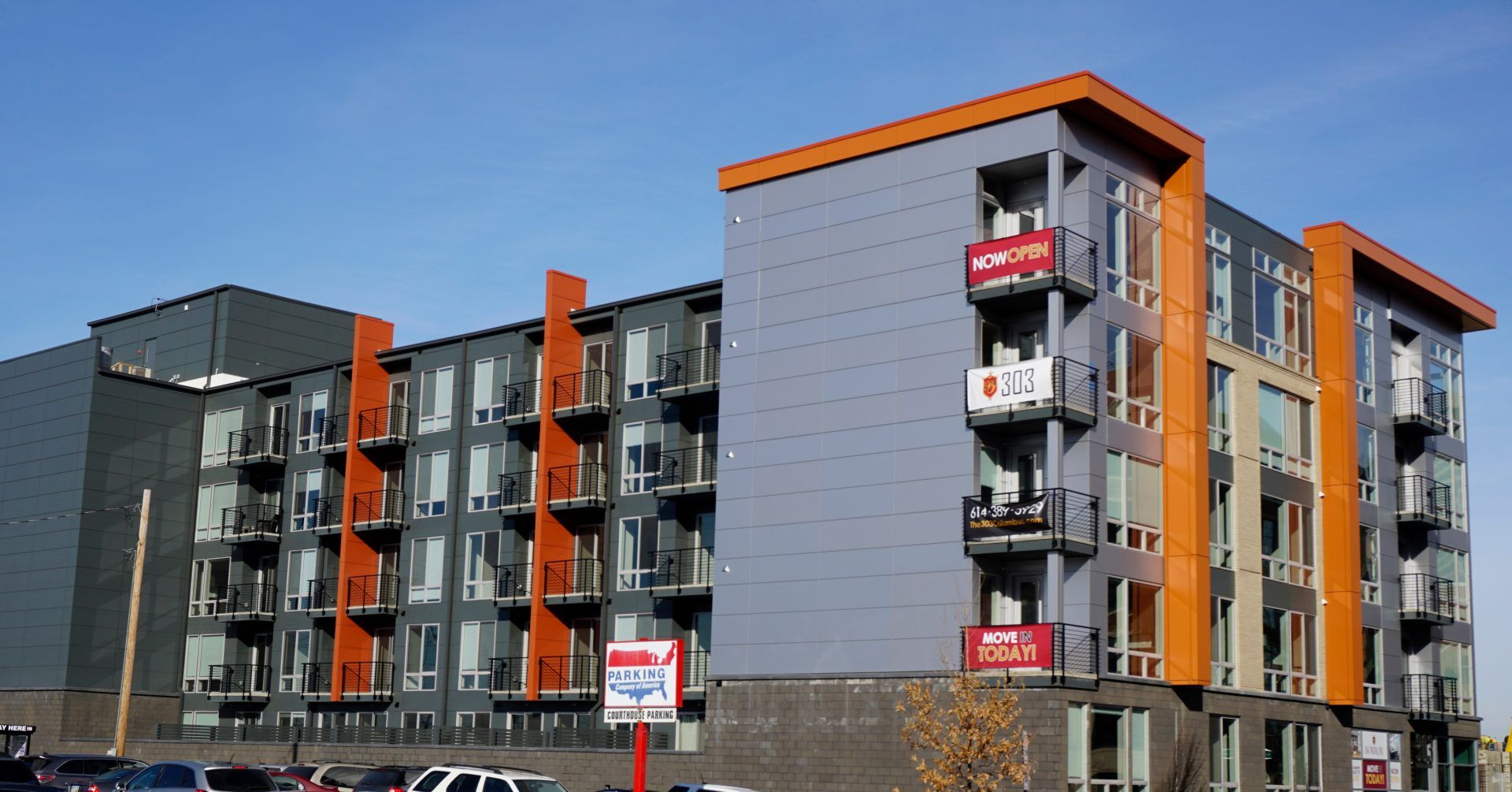 A large apartment building with a lot of windows and balconies.