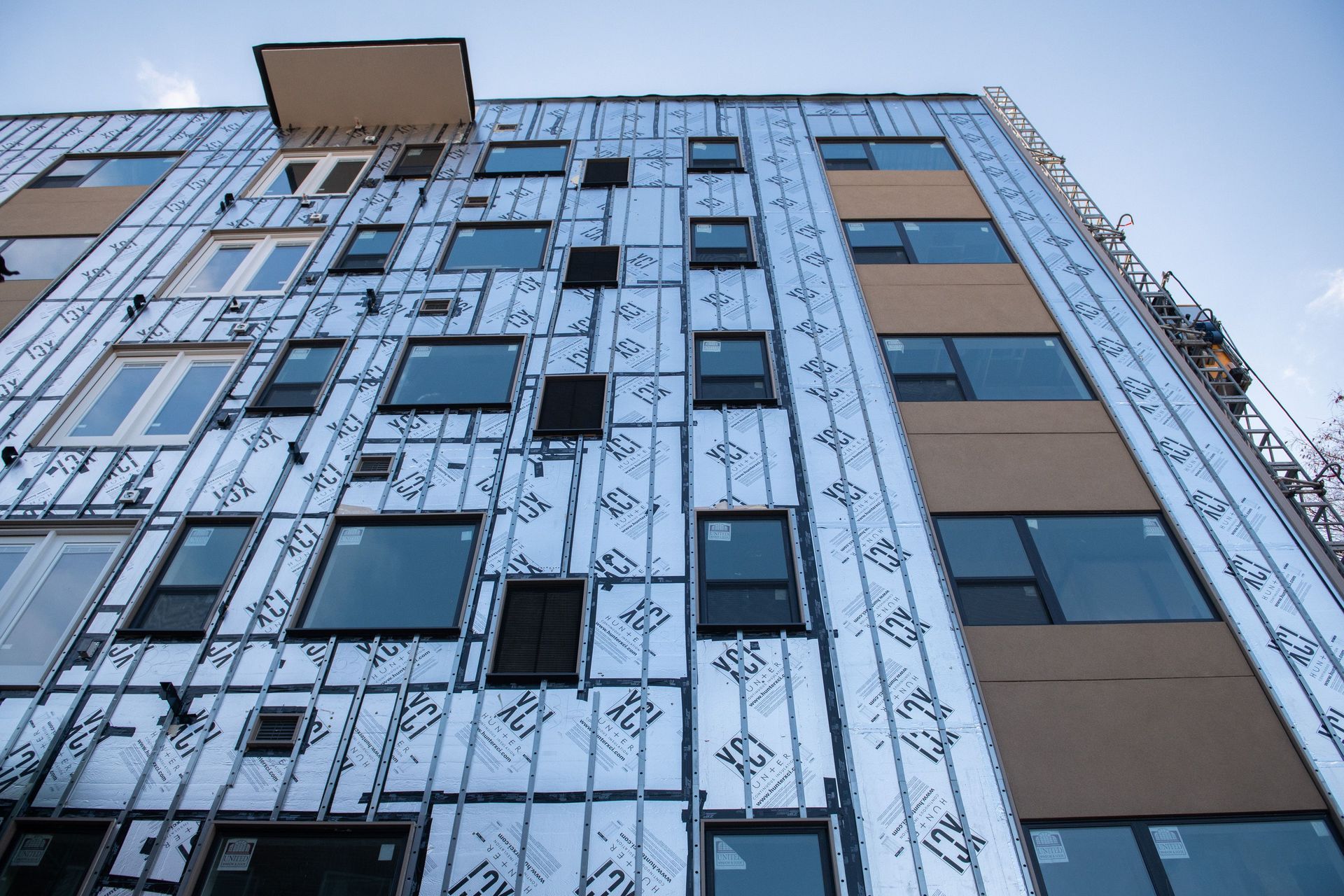 A large building with a lot of windows is being built.