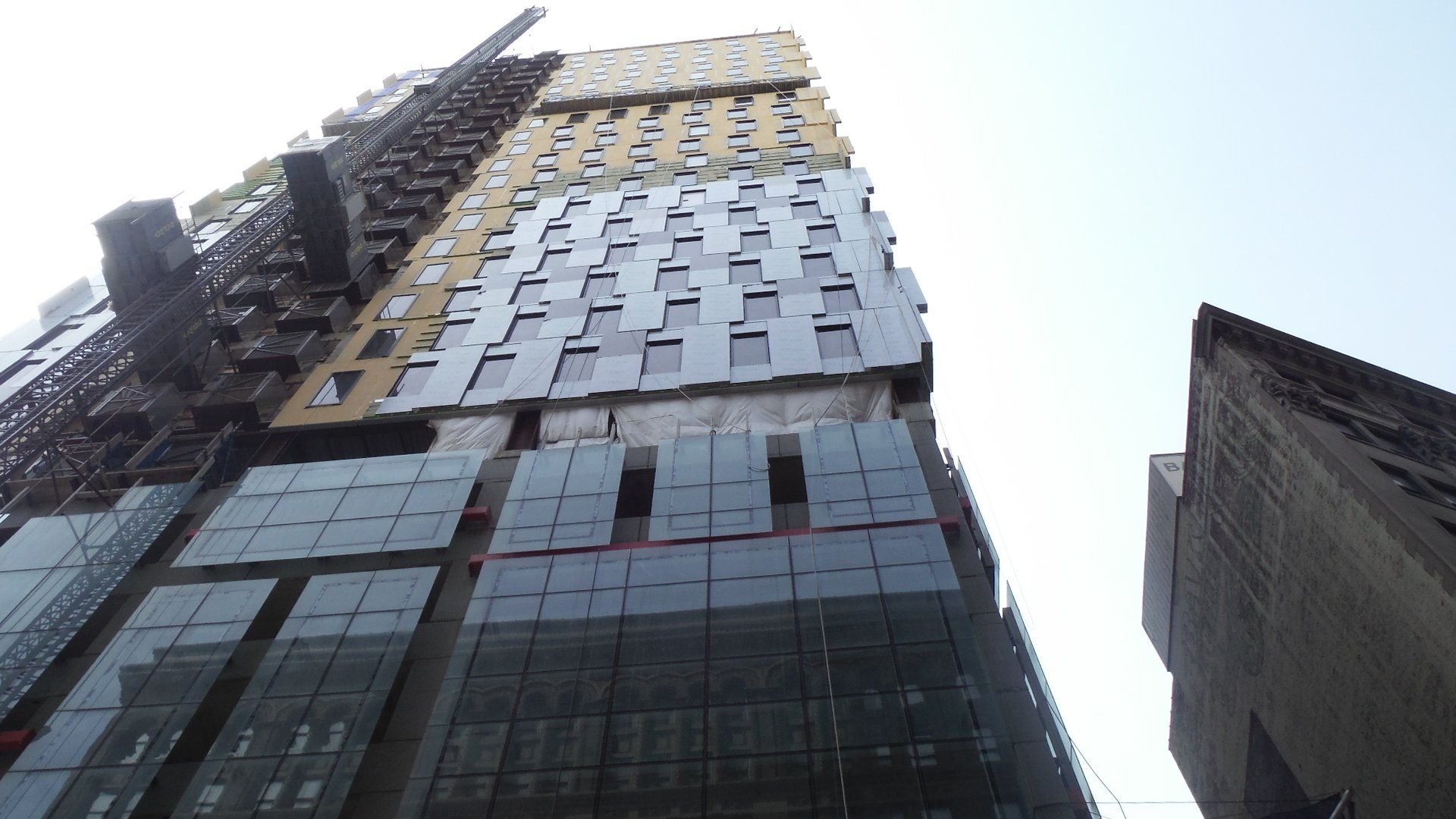 Looking up at a tall building with a lot of windows.