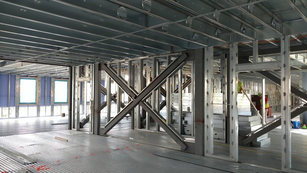 A large building under construction with a lot of metal beams.
