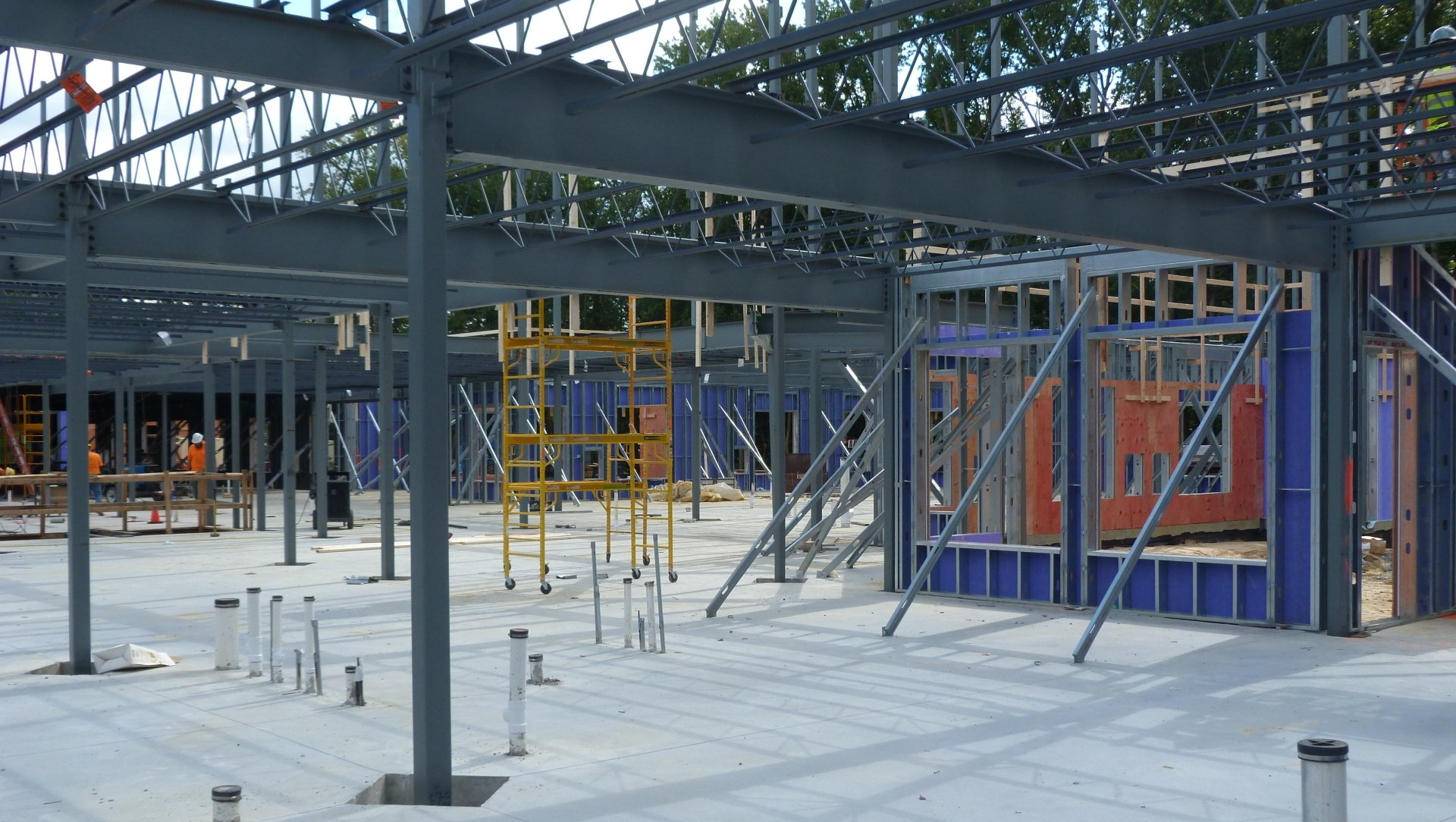 A large building under construction with a lot of steel beams.