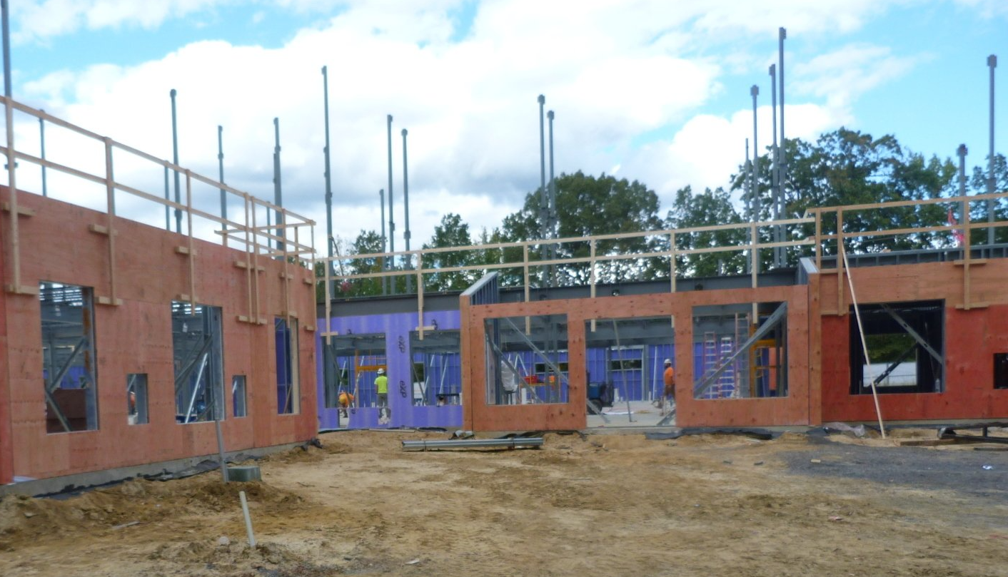 A building under construction with a lot of bricks and scaffolding.