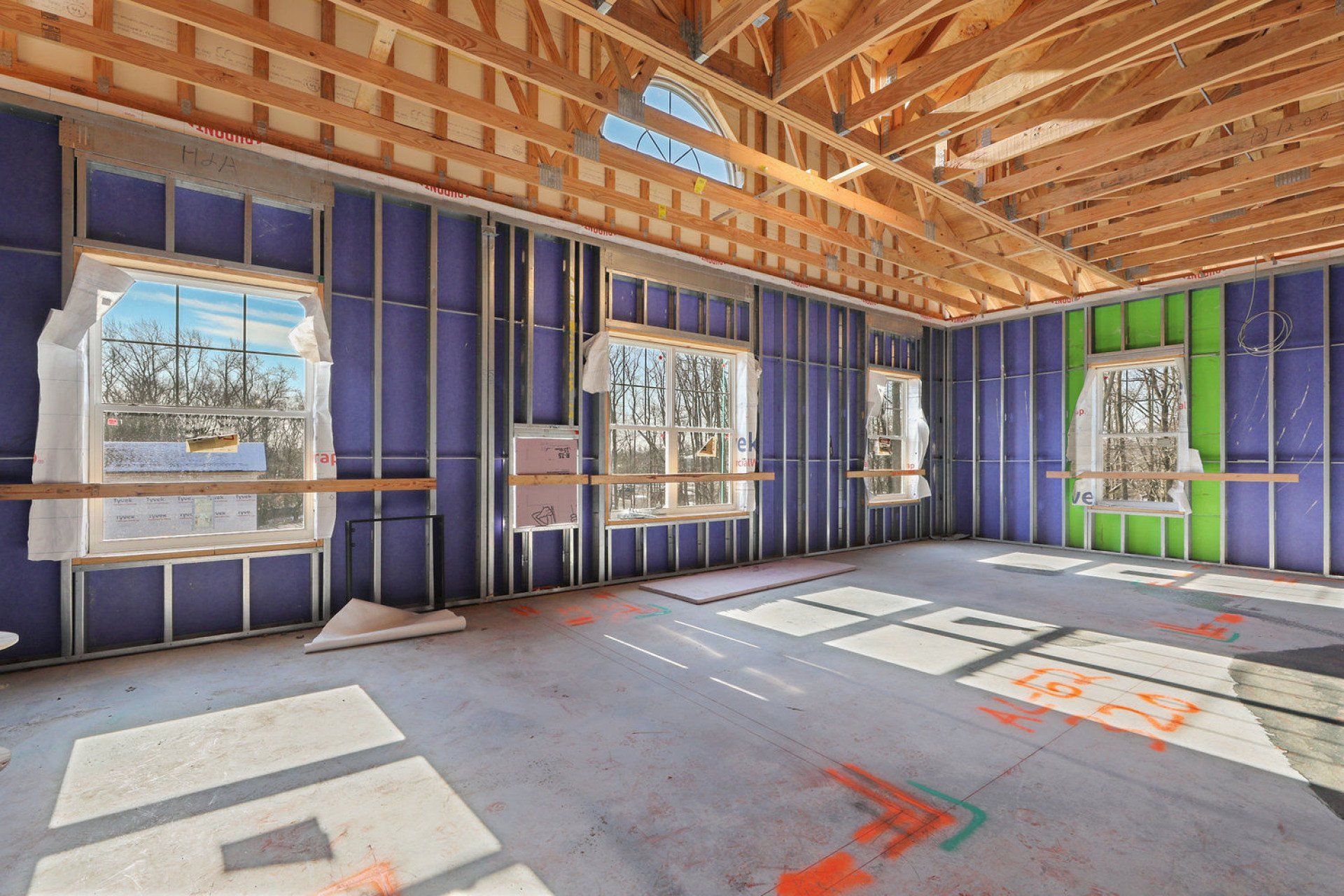 The inside of a building under construction with a lot of windows.