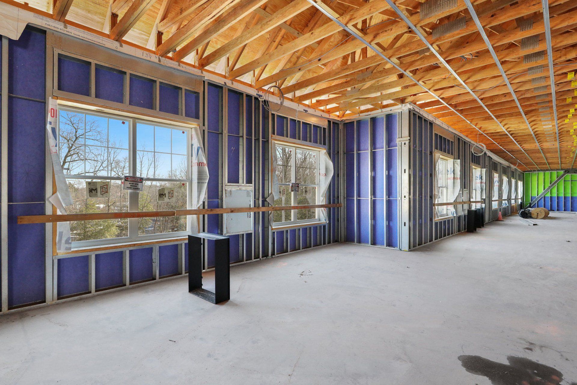 The inside of a building under construction with a lot of windows.