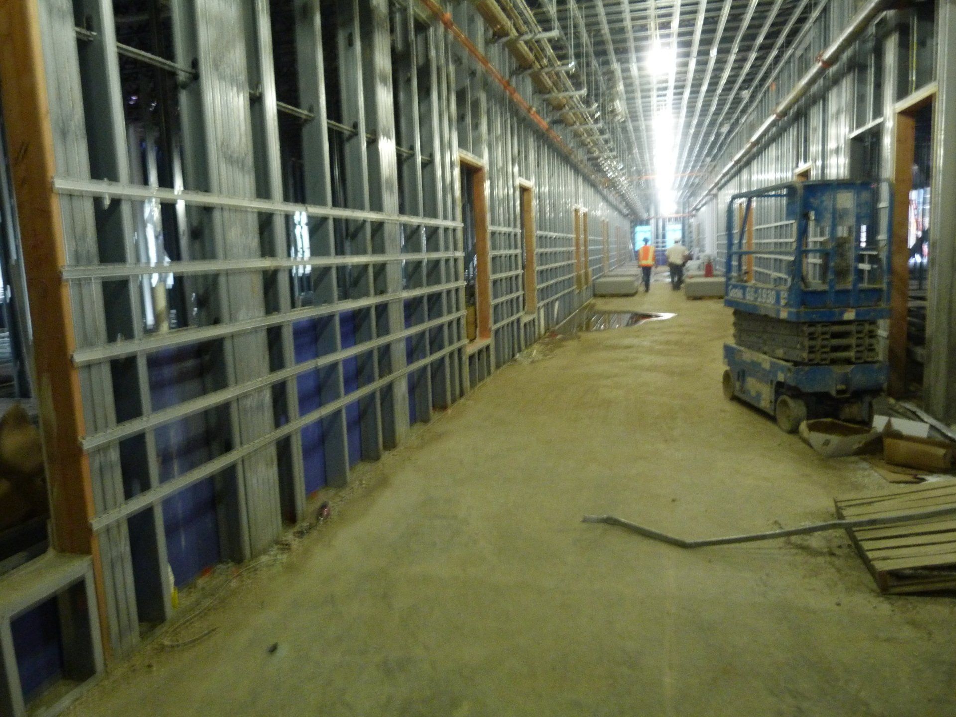 A long hallway in a building under construction.