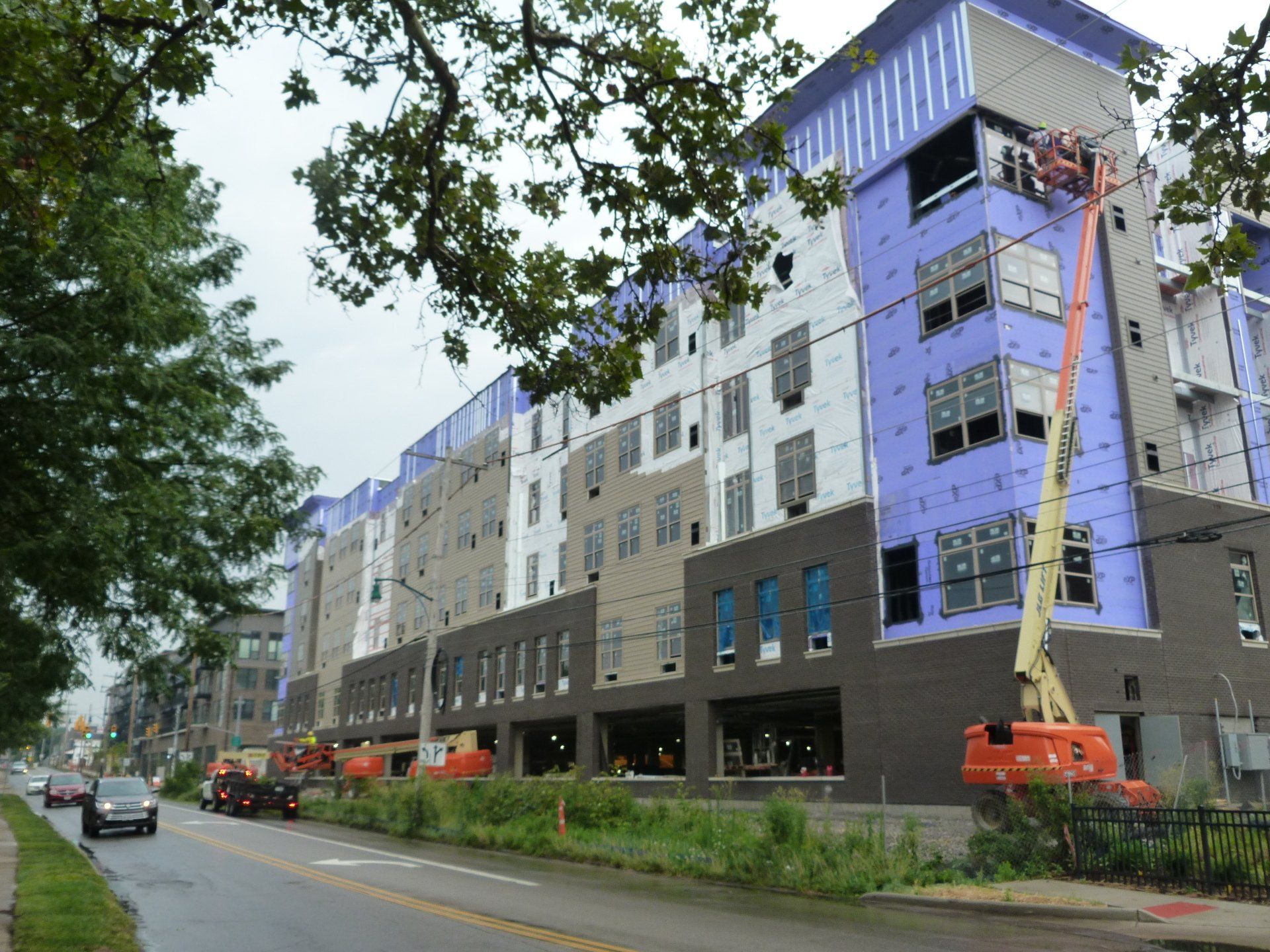A large building is being built on the side of the road.