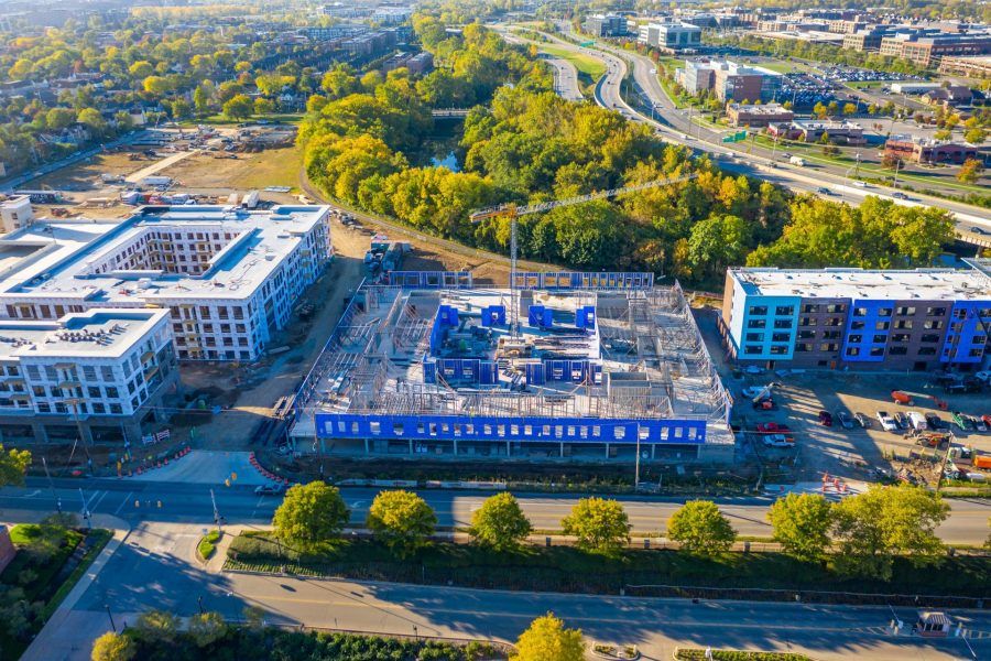 An aerial view of a large building under construction in a city.