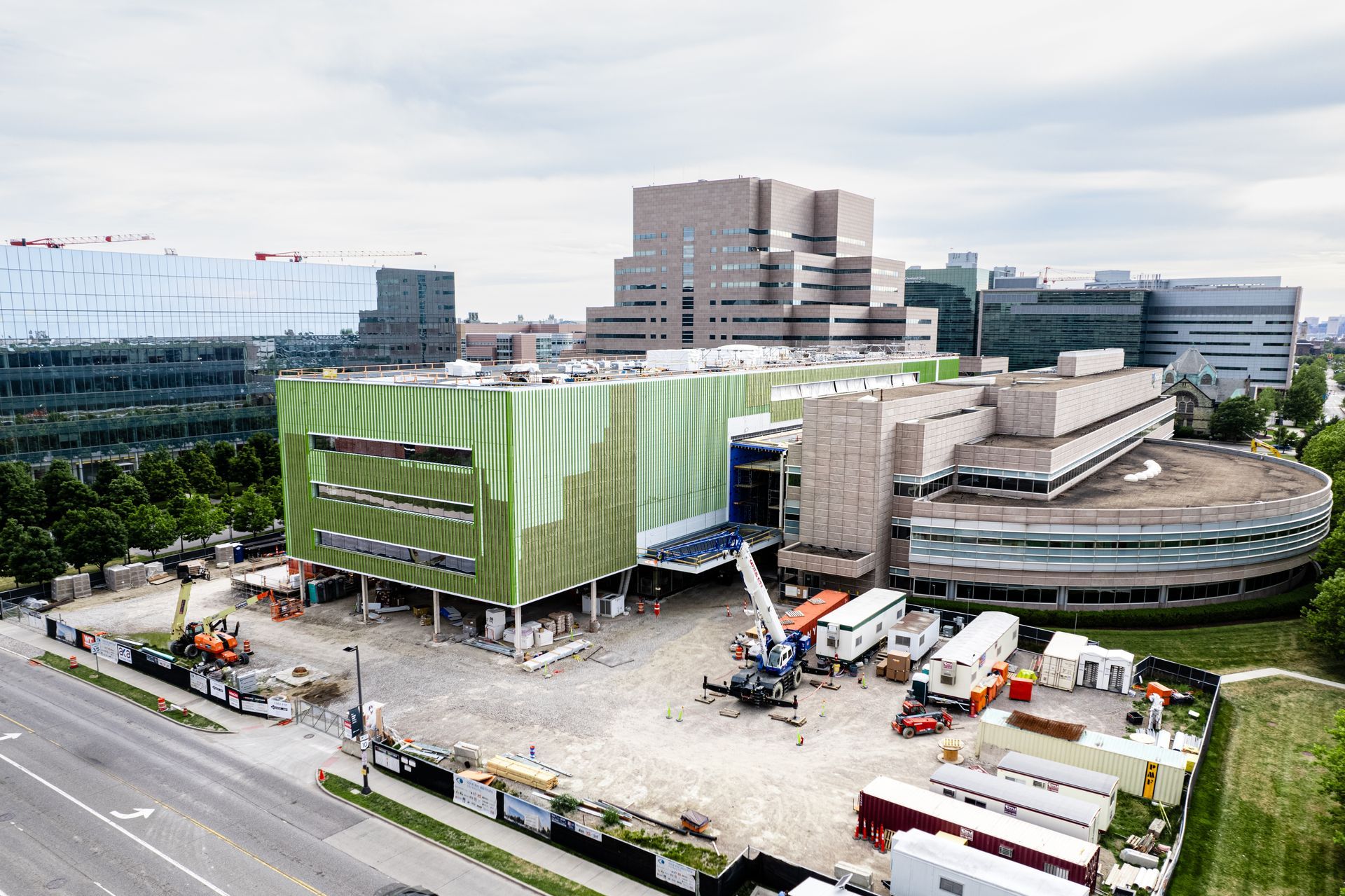 An aerial view of a large building under construction in a city.