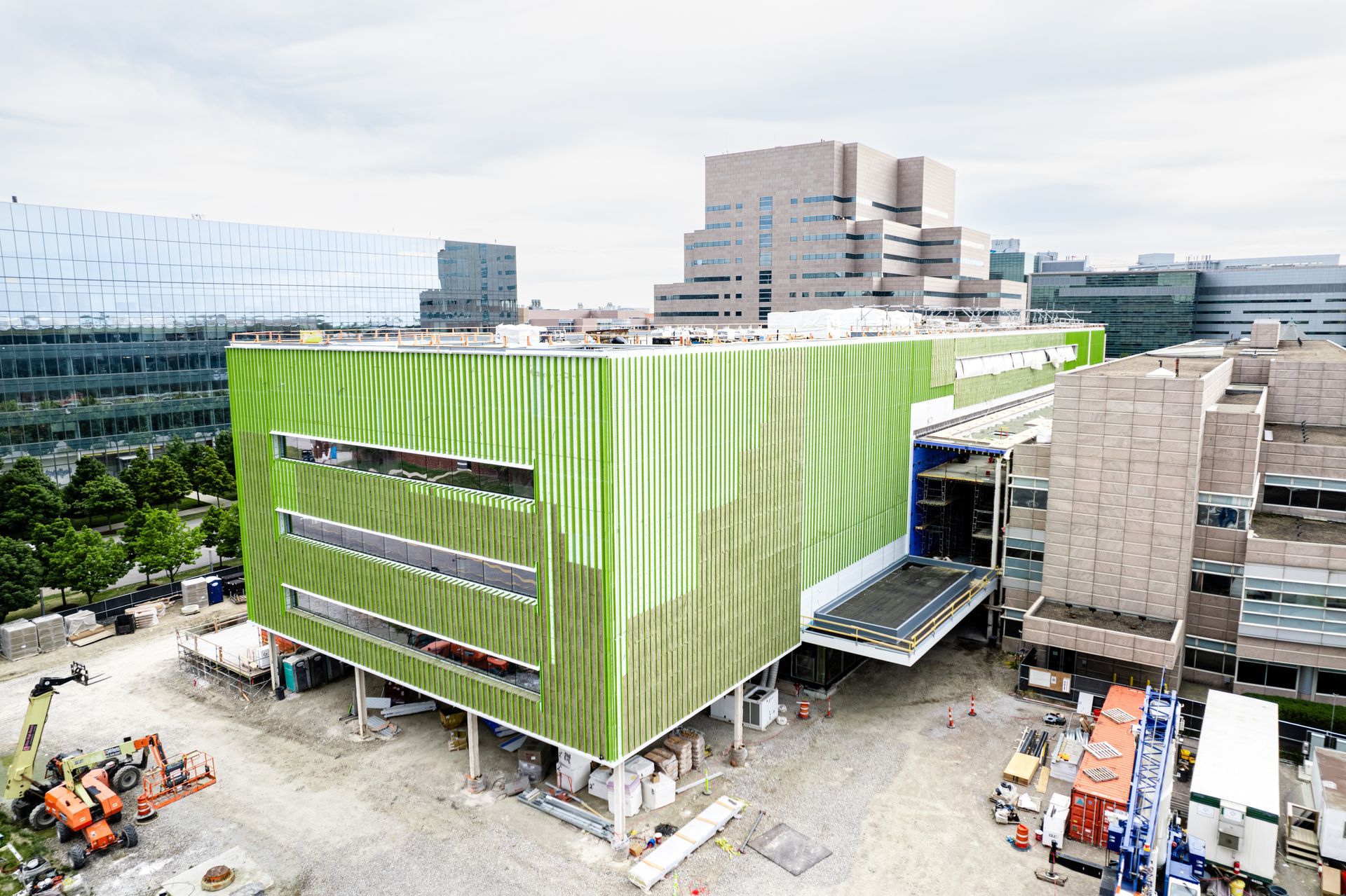 An aerial view of a large green building under construction.