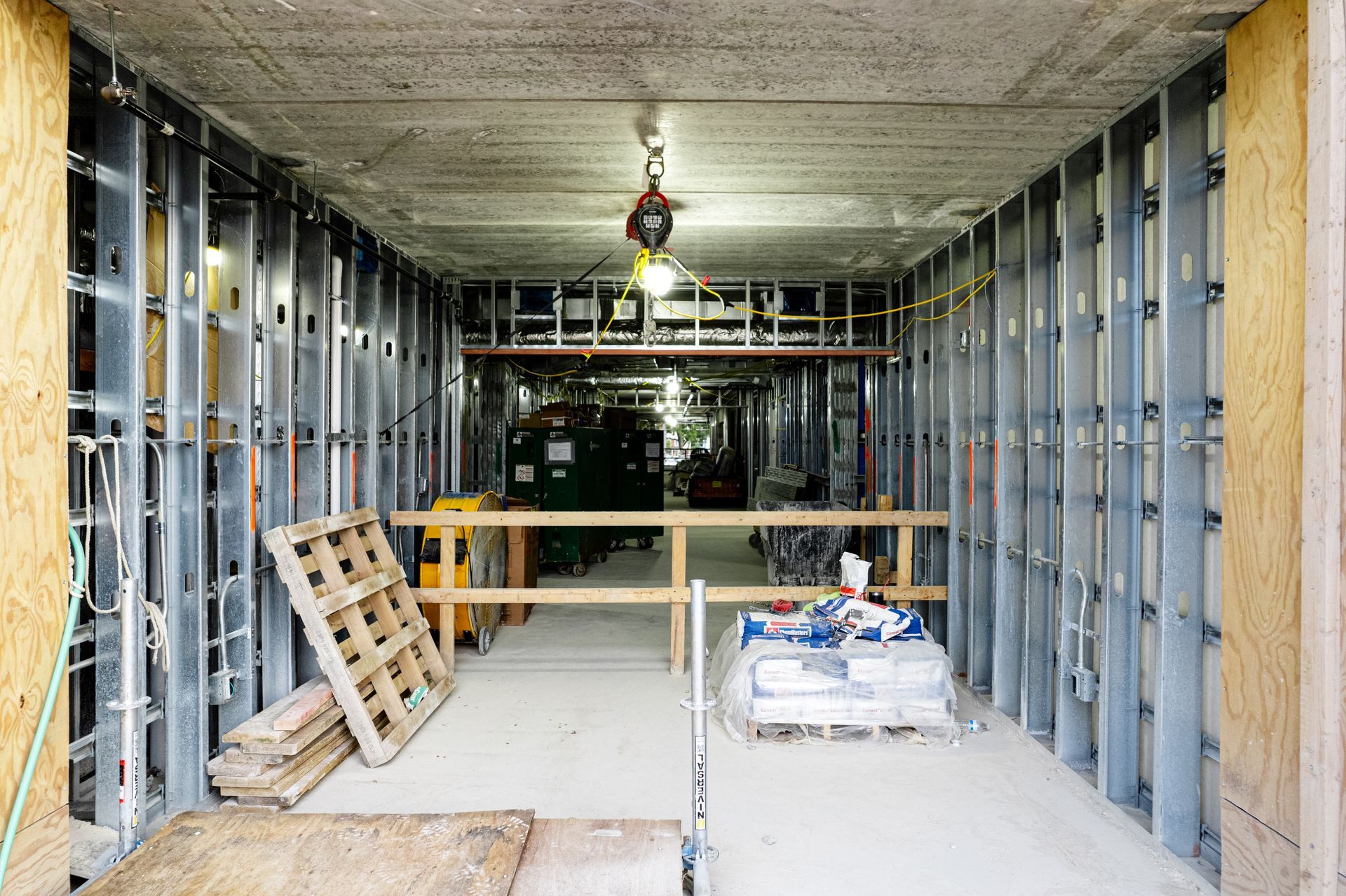 A building under construction with a wooden pallet on the floor.
