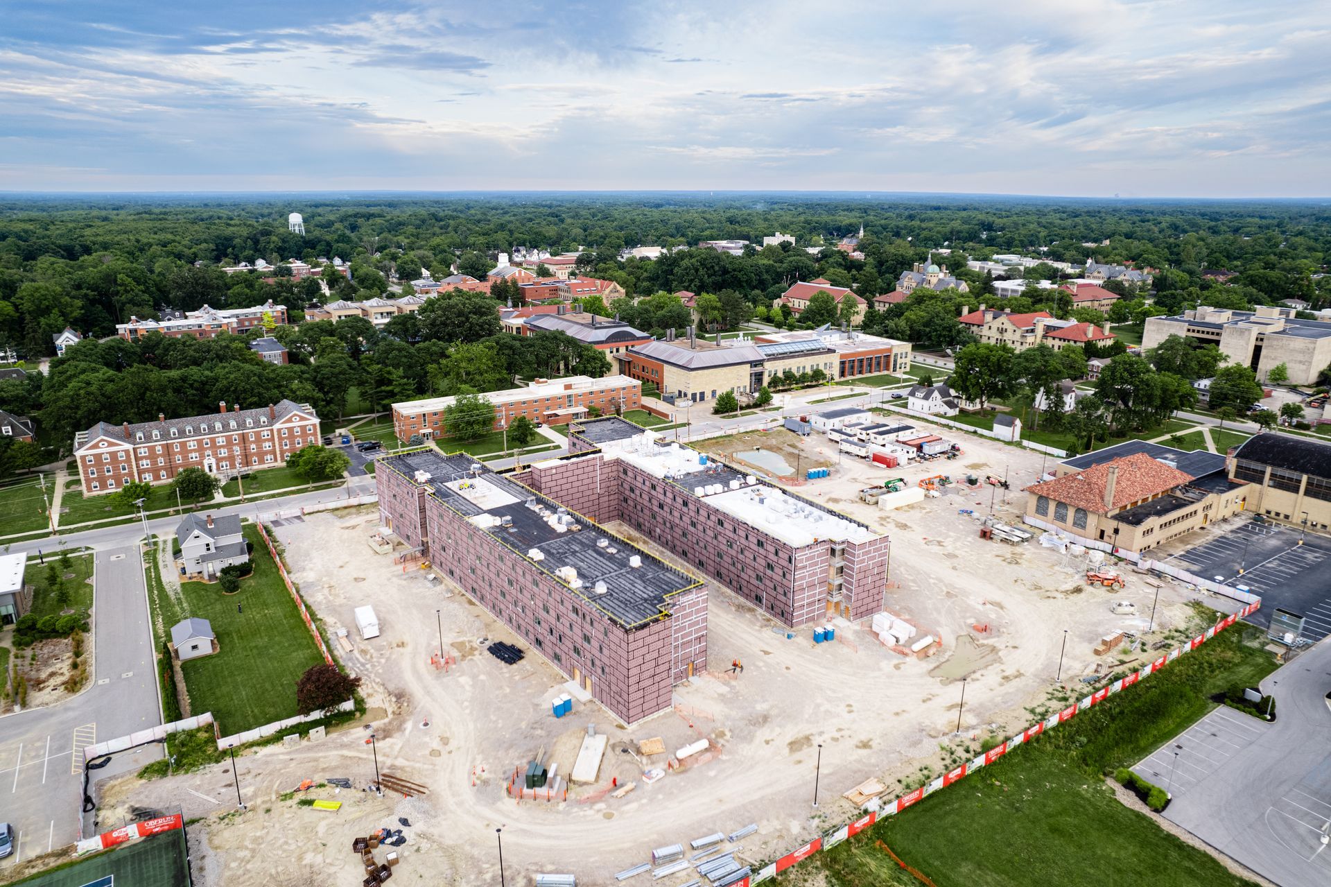 An aerial view of a building under construction in a city.
