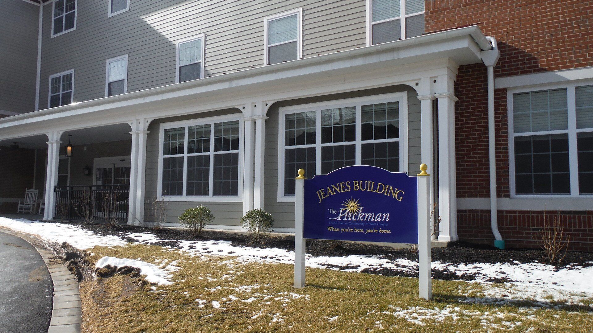 A large building with a blue sign in front of it.