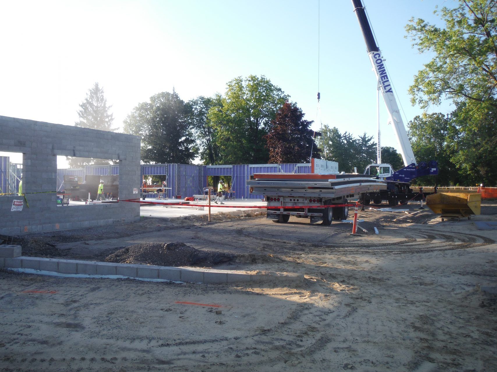 A building under construction with a crane in the background.