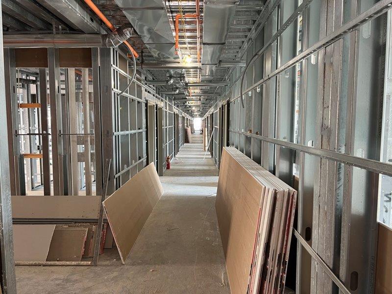 A long hallway in a building under construction.