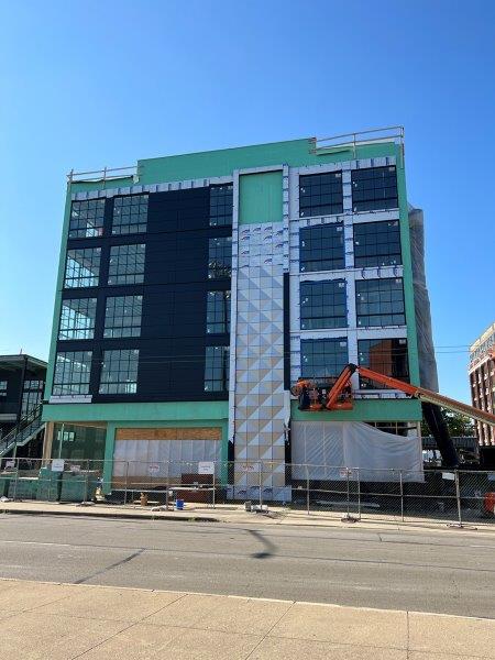 A large building with a lot of windows is being built.