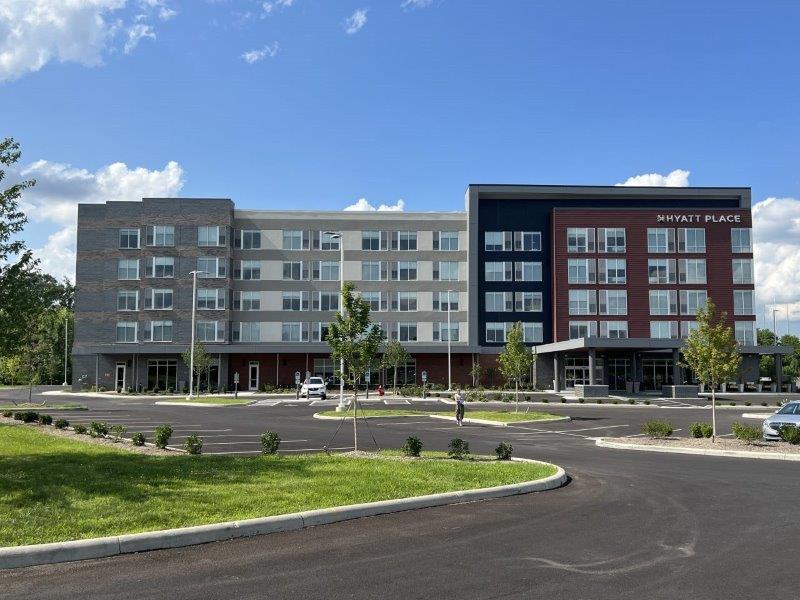 A large building with a parking lot in front of it.