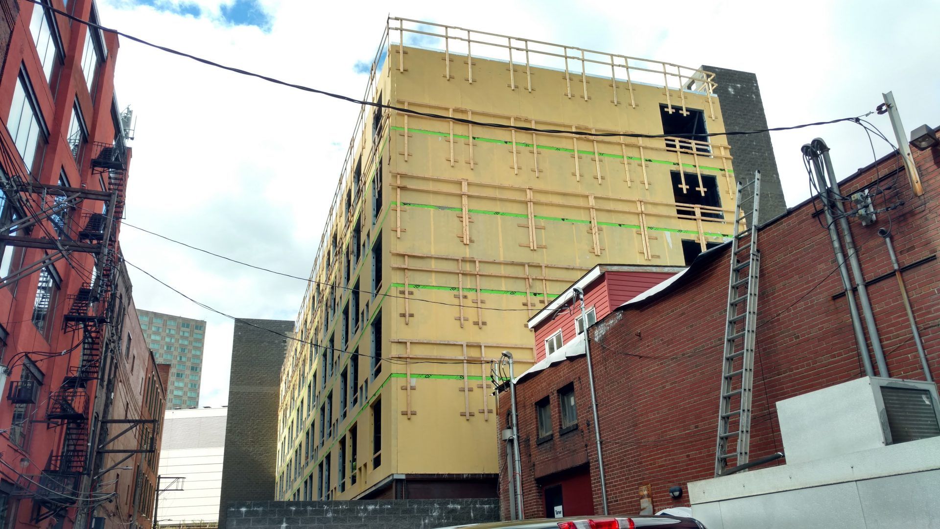 A large building is being built in the middle of a city.