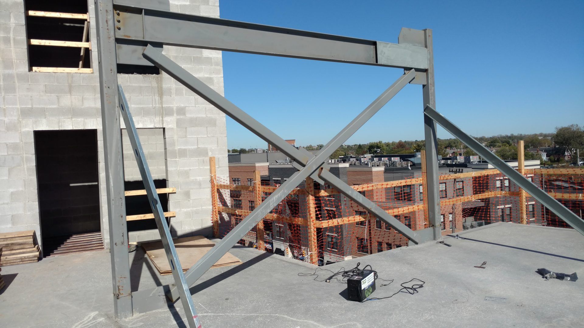 A building under construction with a metal structure in the foreground.