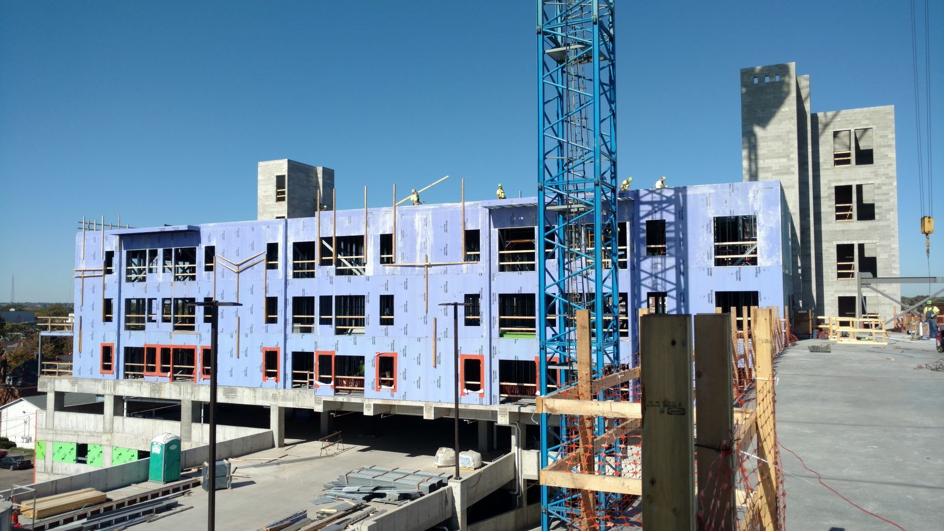 A large building under construction with a crane in the foreground.