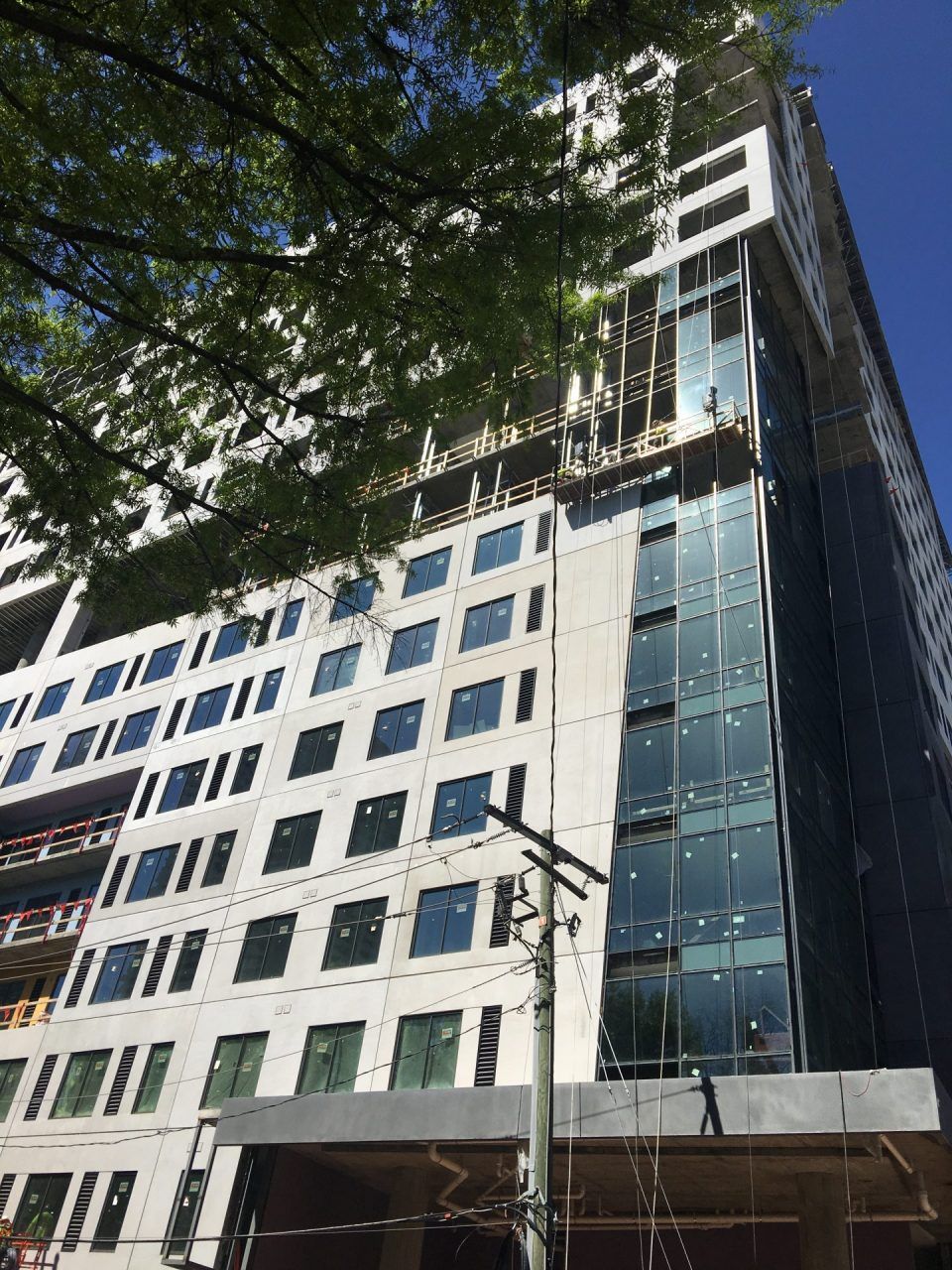 A large building with a lot of windows is under construction.