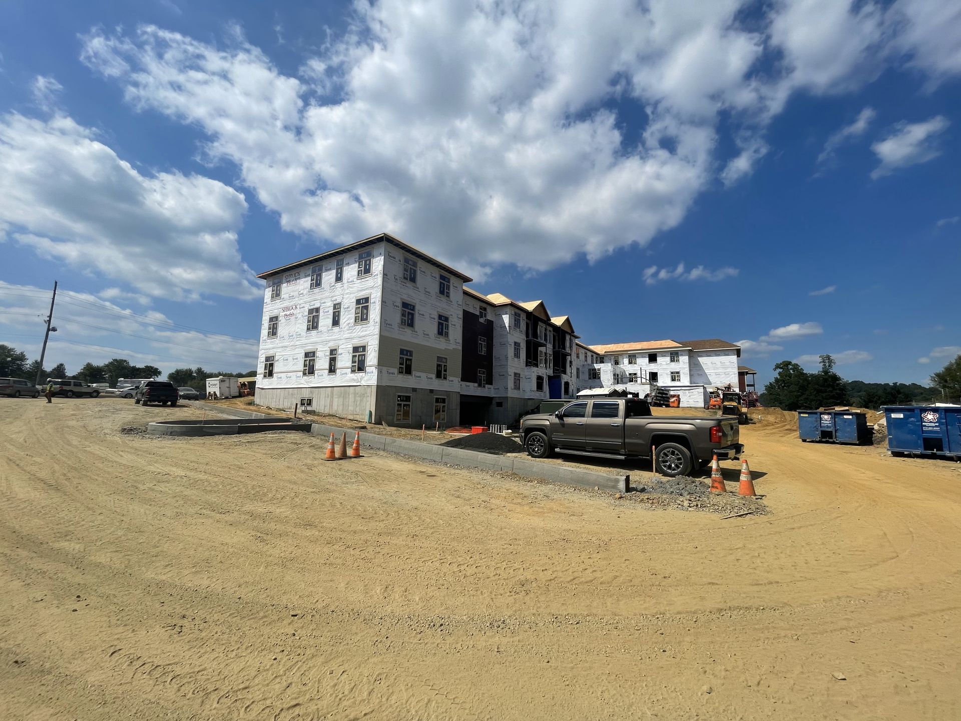 A truck is parked in front of a building under construction.