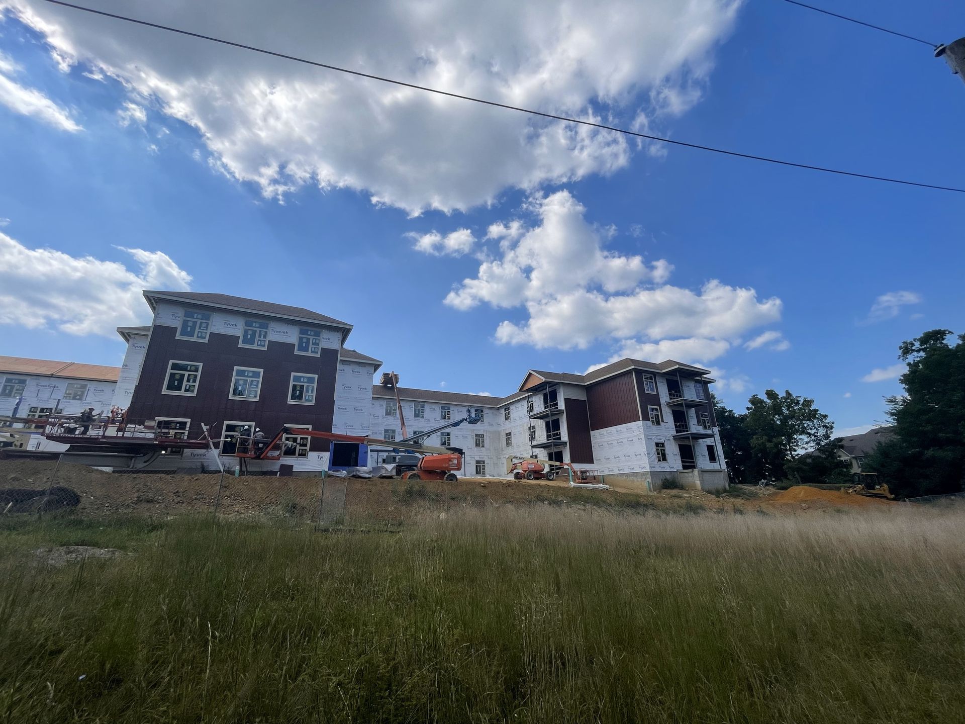 A group of buildings are being built in a field.